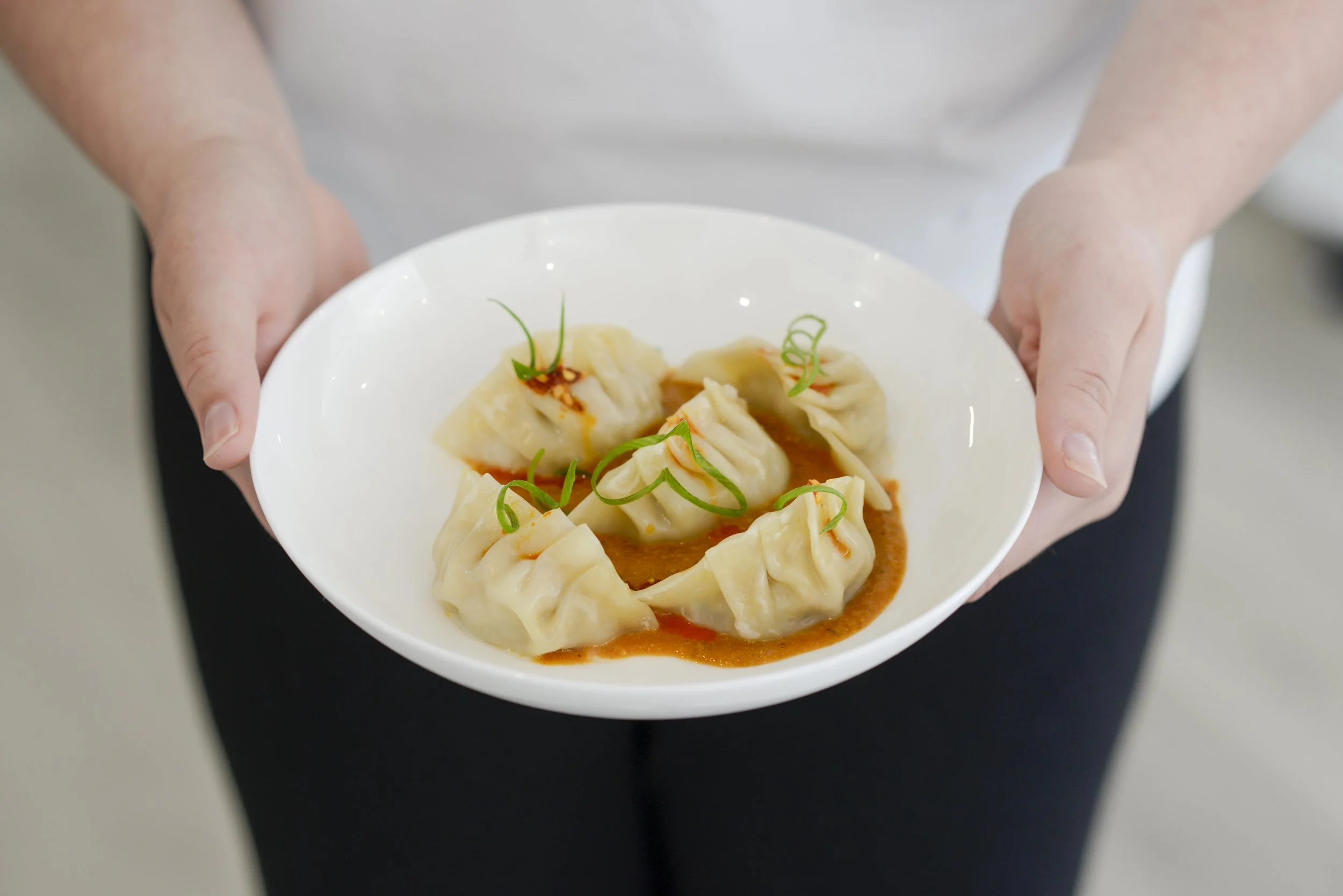 Housemade chicken momo with tomato sesame and sezwan chutney