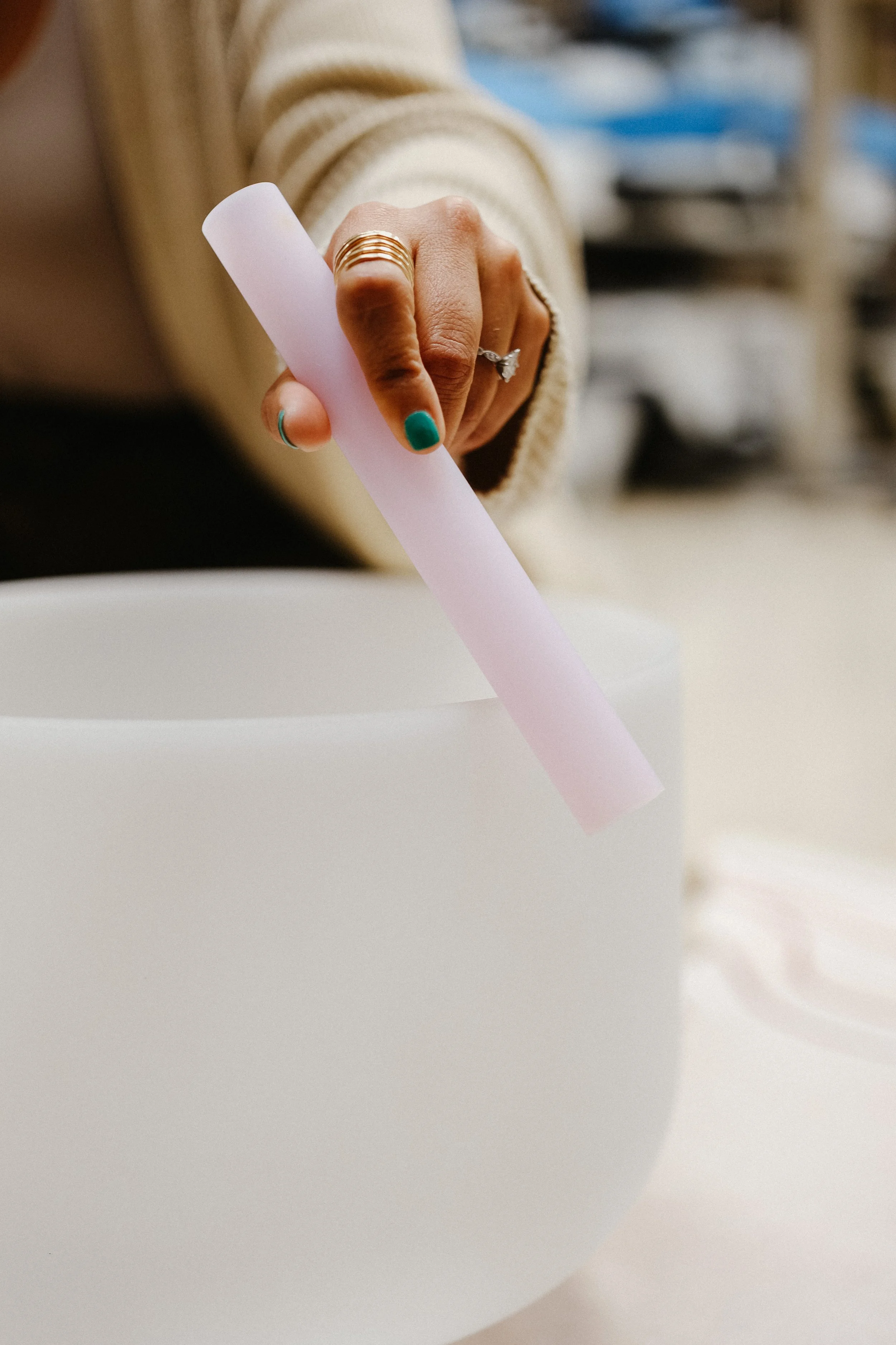 Sync'd wellness sound healing guide playing crystal singing bowls during corporate wellness session in phoenix for relaxation, calm, and nervous system regulation