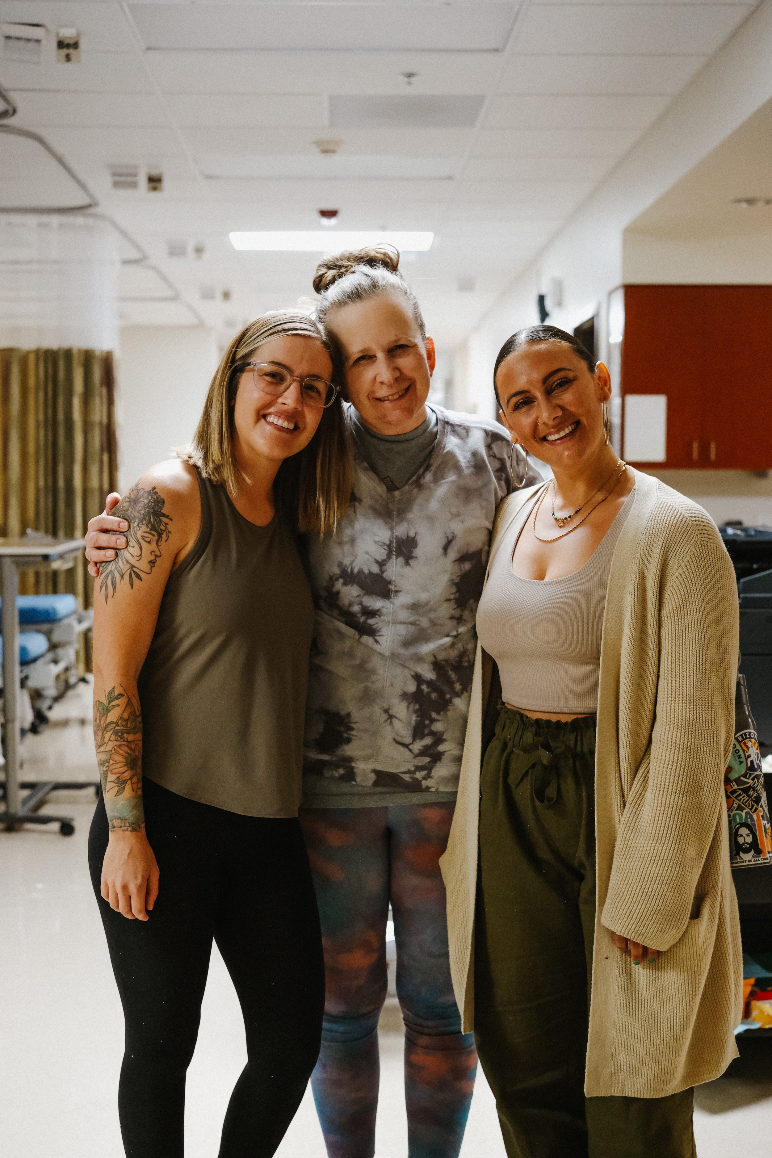 Sync'd wellness team and  surgery center employee smiling together after corporate wellness session