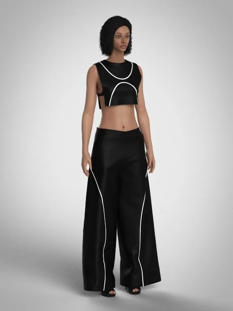 Woman wearing a black crop top and wide-leg pants with white piping, standing against a plain gray background.