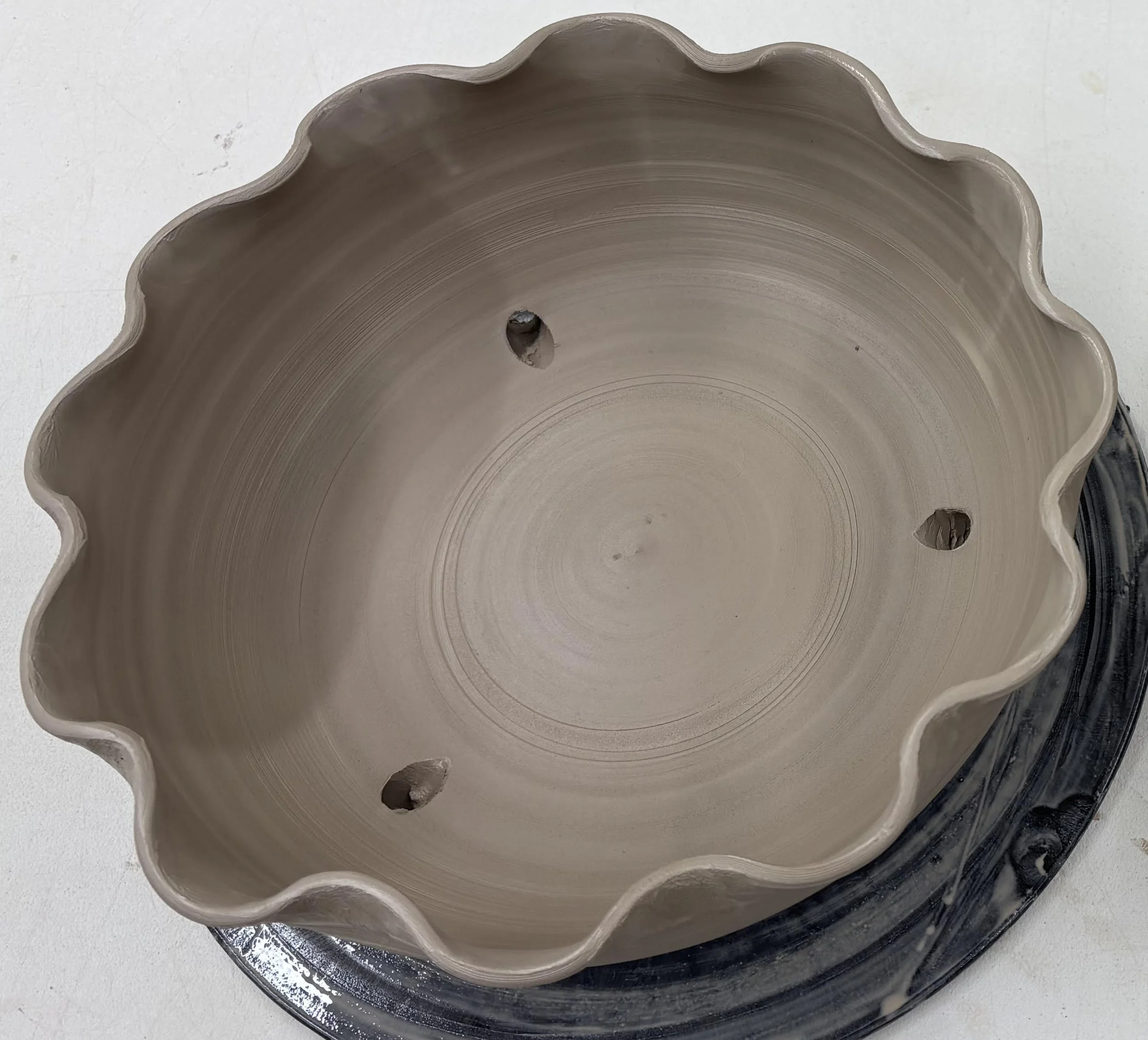 Unfinished 10inch, shallow flower pot with a scalloped edge.