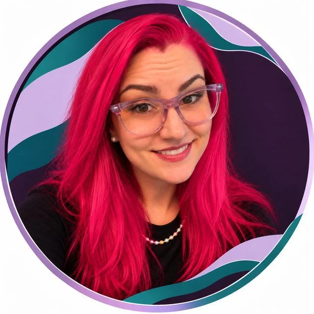 Rebecca Viereckl-Grush, M.S., LMFT, CTP, smiling, with long pink hair and lavender glasses