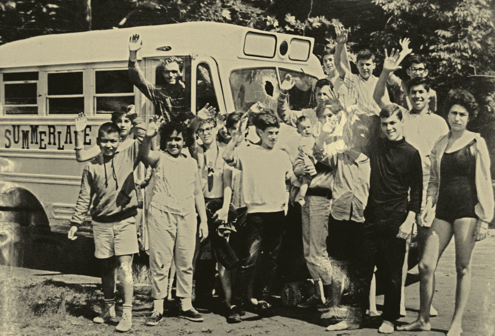    A group of Camp Summerlane (Rosman, NC) campers in front of their bus with the windshield shot out, c. 1963. Photo courtesy of Mountain Xpress   