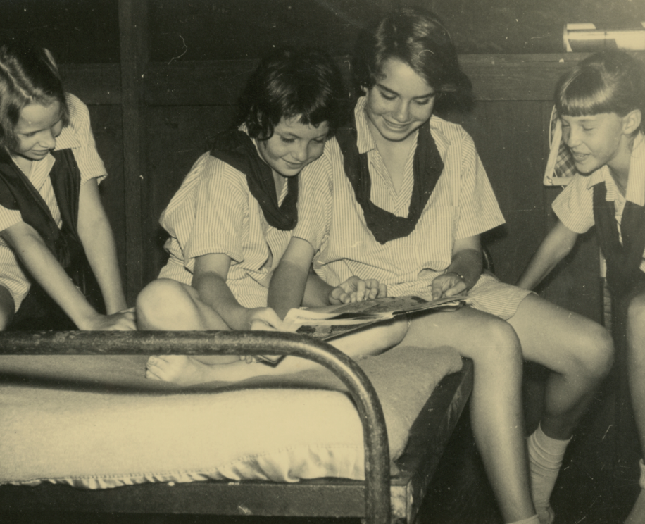    Campers at Keystone Camp (Brevard, NC) look through a magazine, c. 1950s–1960s   