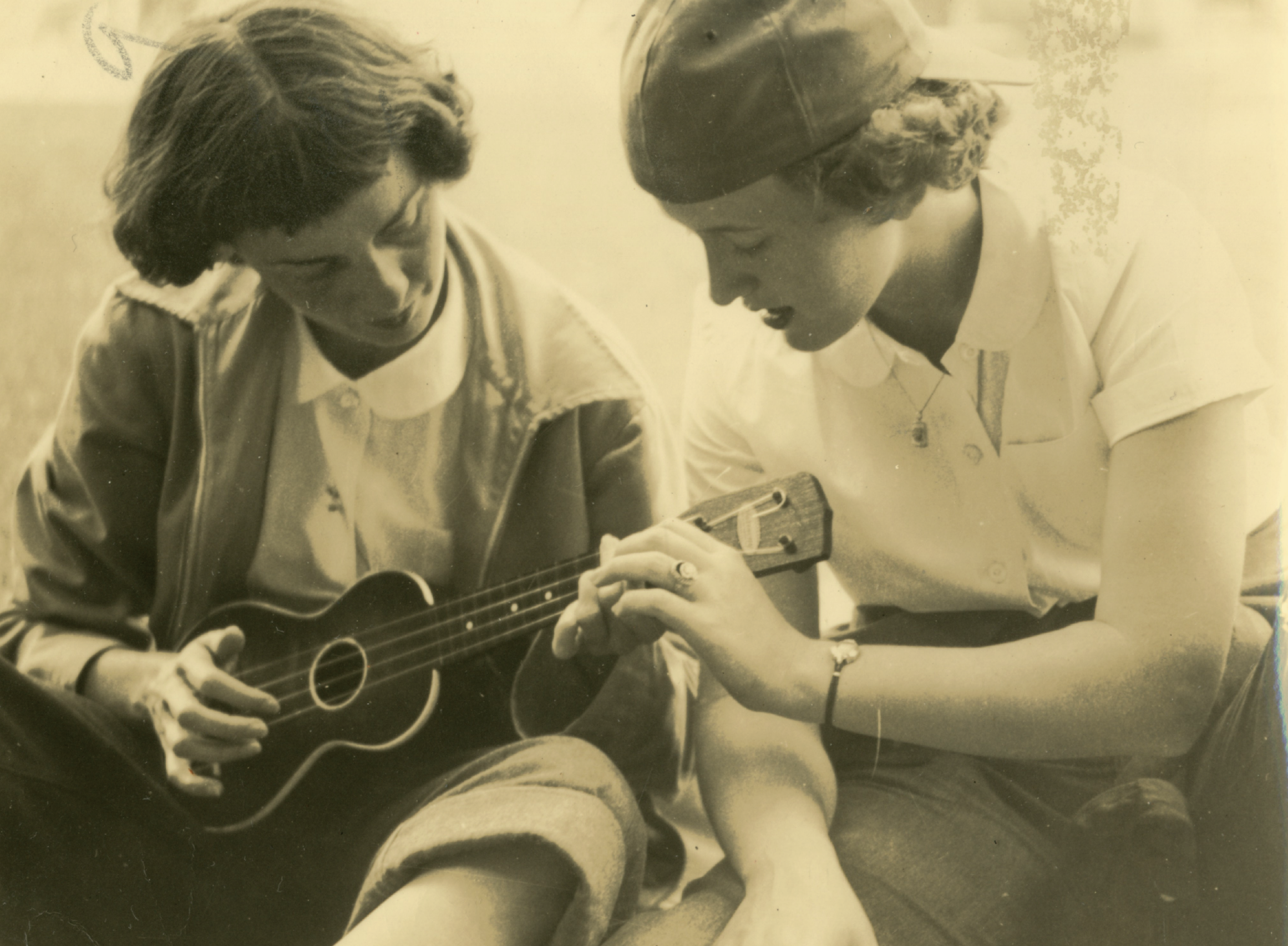    A counselor teaches ukulele to a camper at Camp Junaluska (Lake Junaluska, NC), c. 1950.   