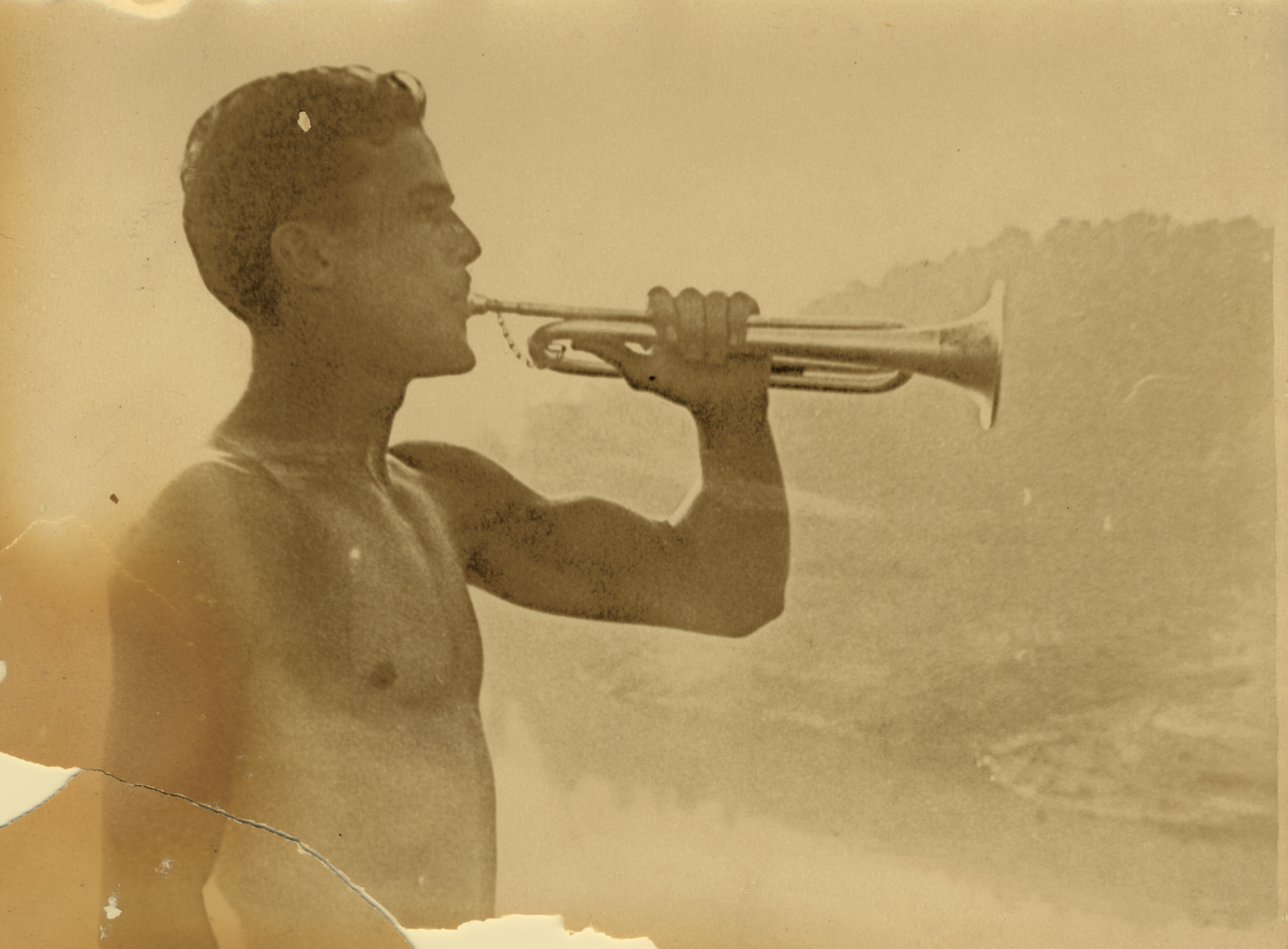   A counselor at Camp Mondamin (Tuxedo, NC) plays the bugle, c. 20th century.   