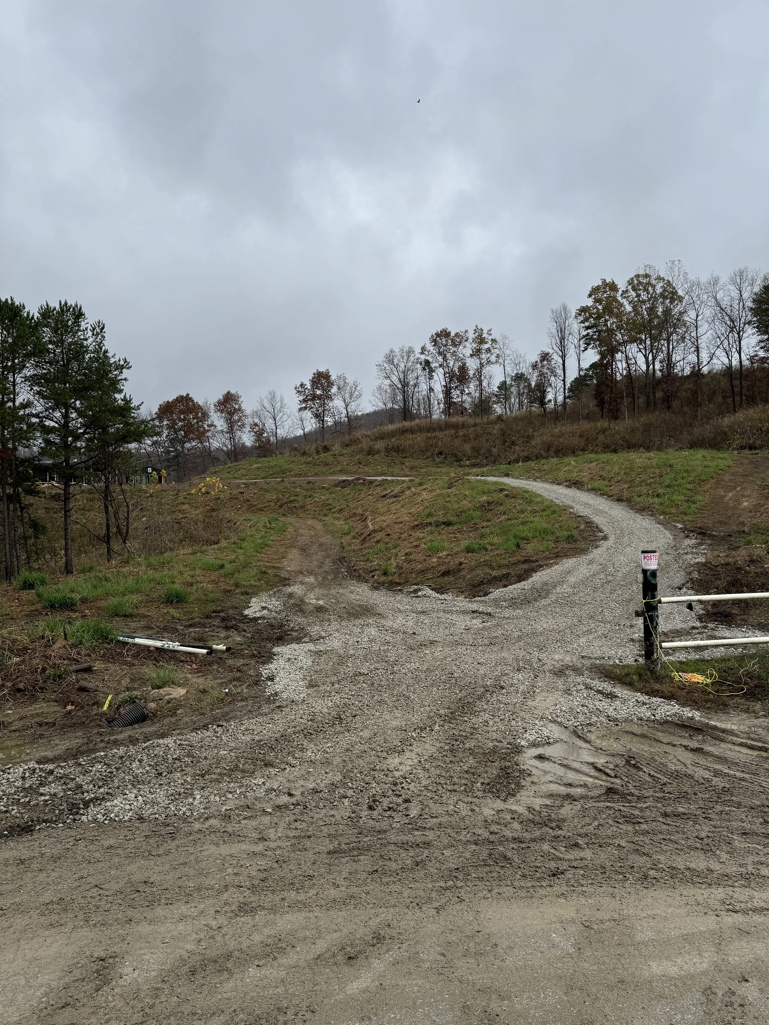 Gravel driveway grading Corbin KY skid steer spreading rock