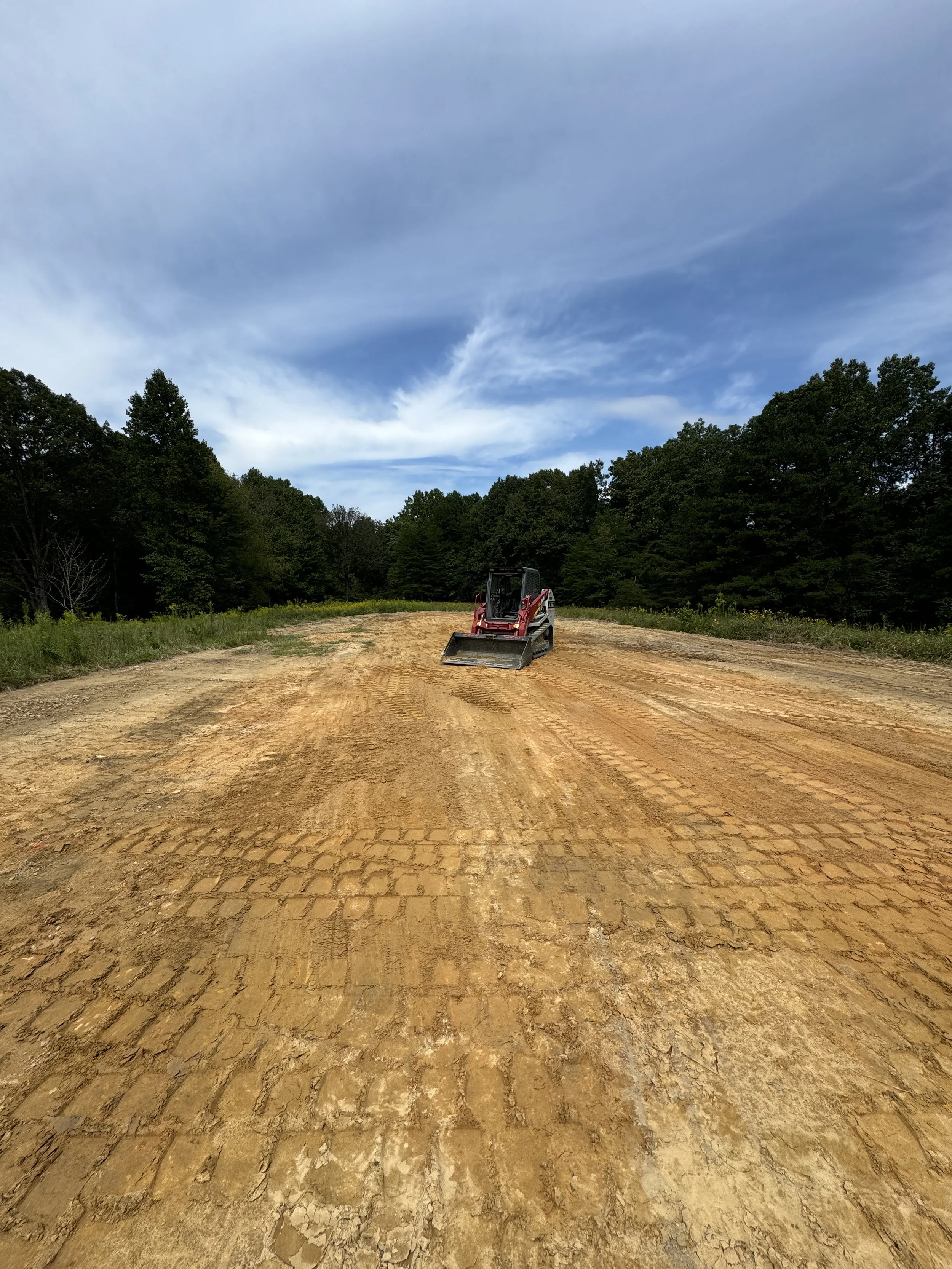  track loader leveling an open field during site prep project 