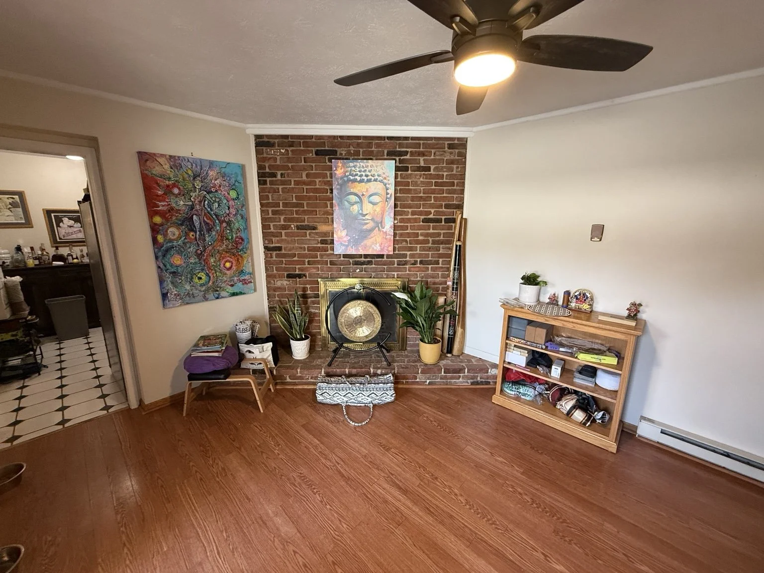 Red Roots Yoga home studio in Mentor, Ohio, with wood floors, yoga props, a gong, and space for private practice.
