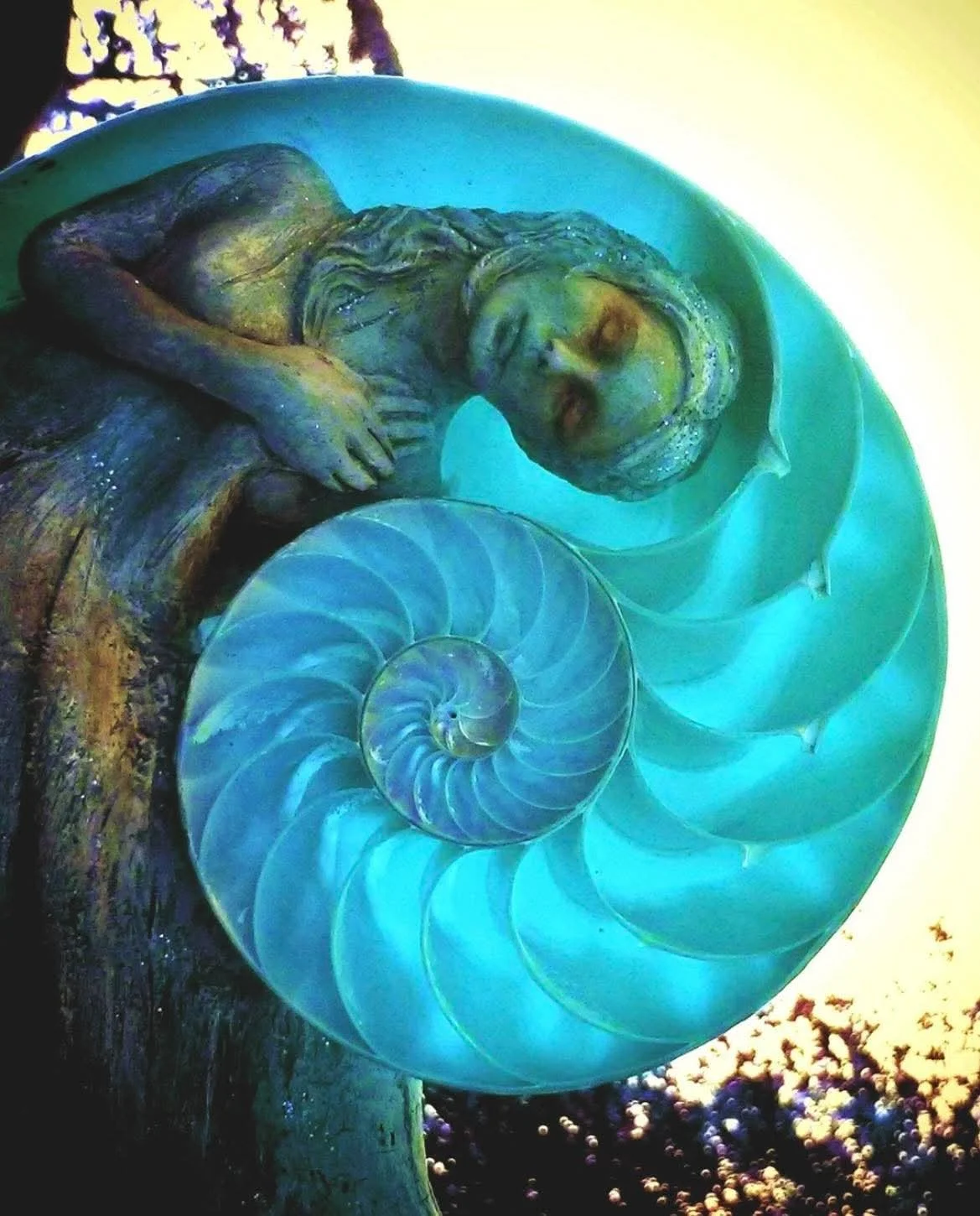 Scenic landscape of a lake surrounded by rolling hills and mountains with cloudy sky above.