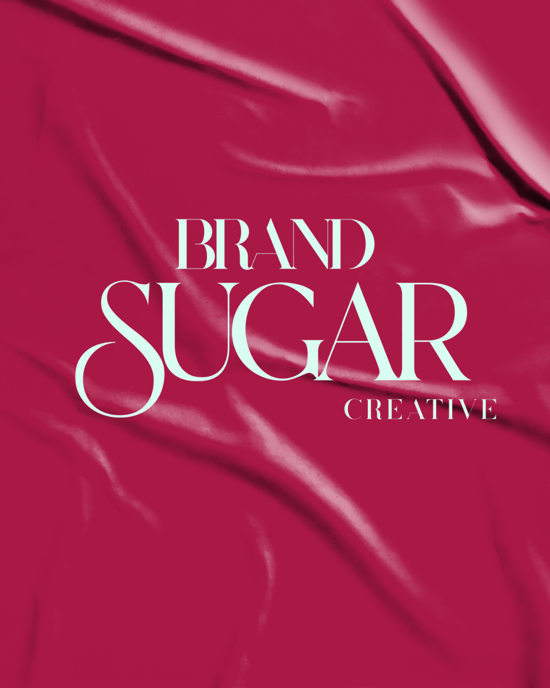 Text overlay reading 'Brand Sugar Creative' on a satin pink fabric background.