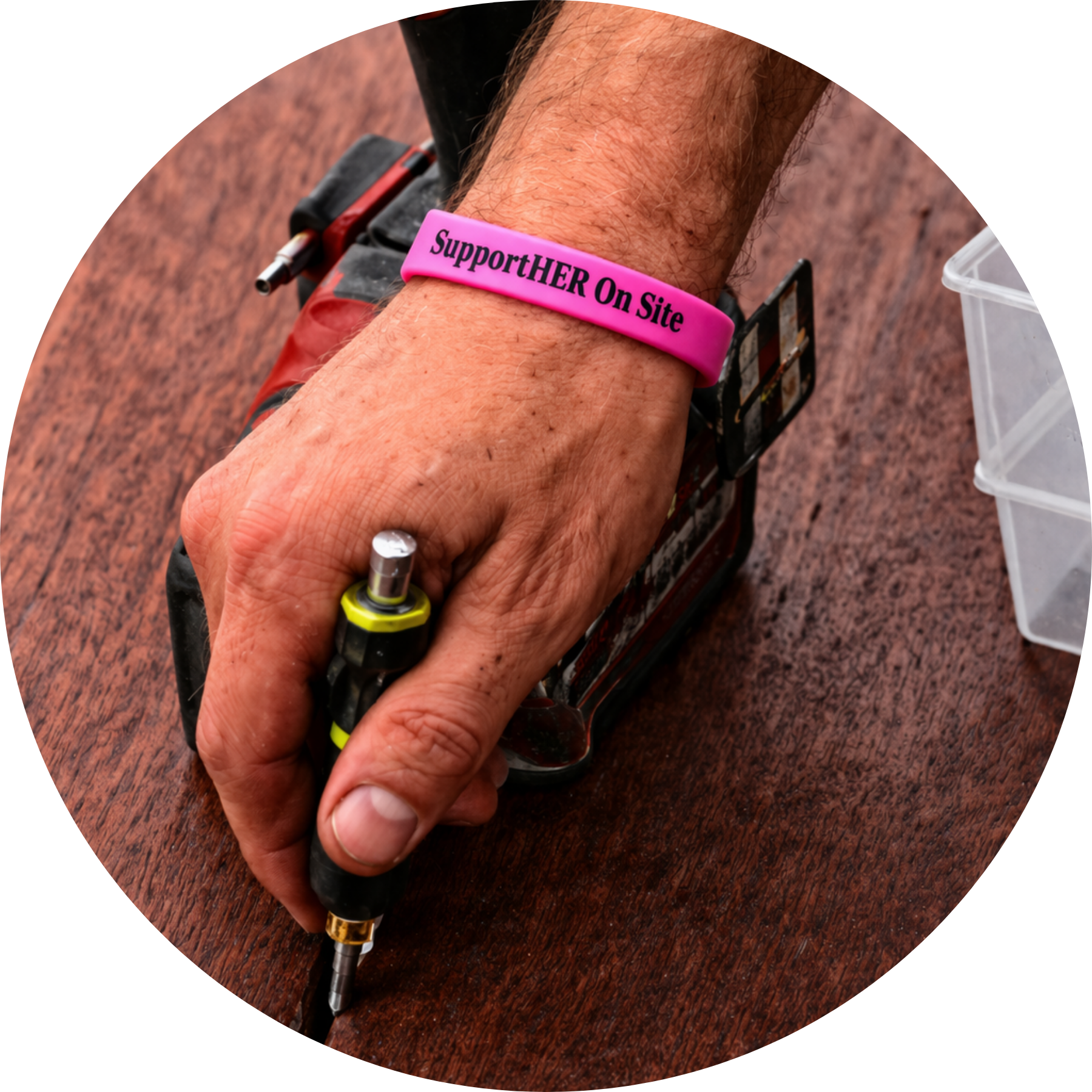 SupportHER wristband on tradie wrist with tools in background Australia