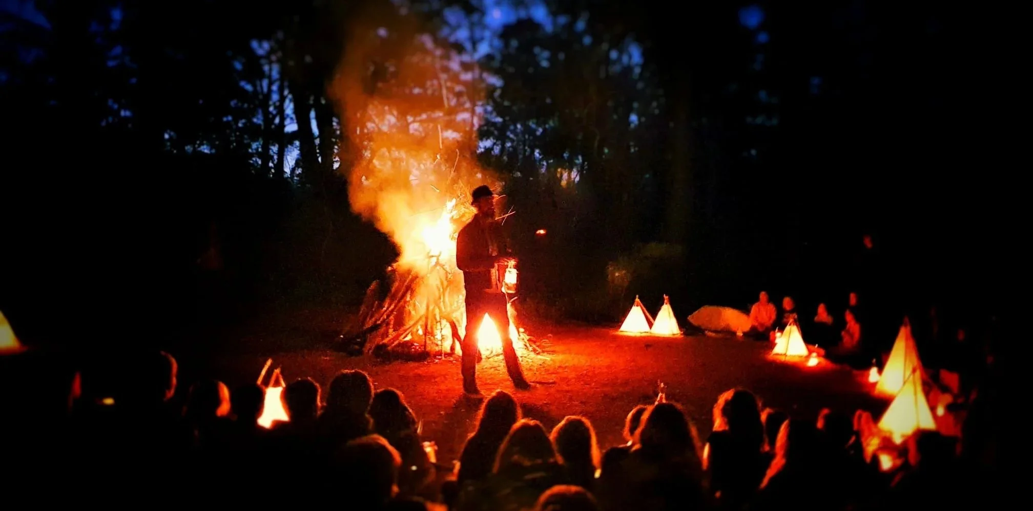 Gathered around a blazing fire the storyteller enthalls a crowd