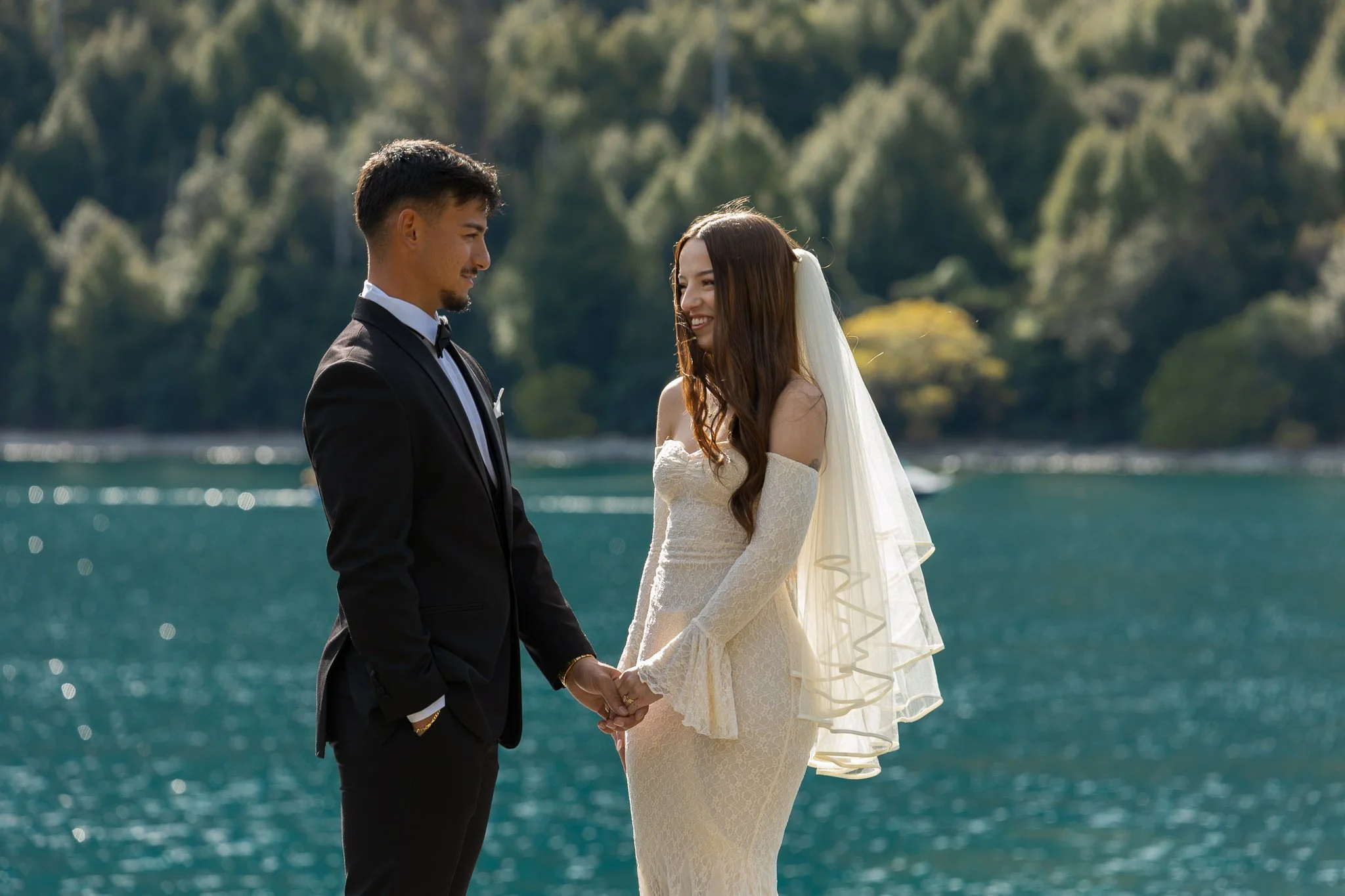 Couple stand by lake Wakatipu Queenstown during their elopement