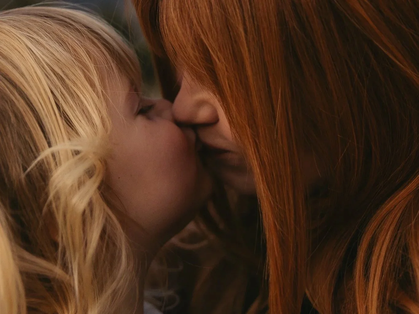 young girl kissing her mum