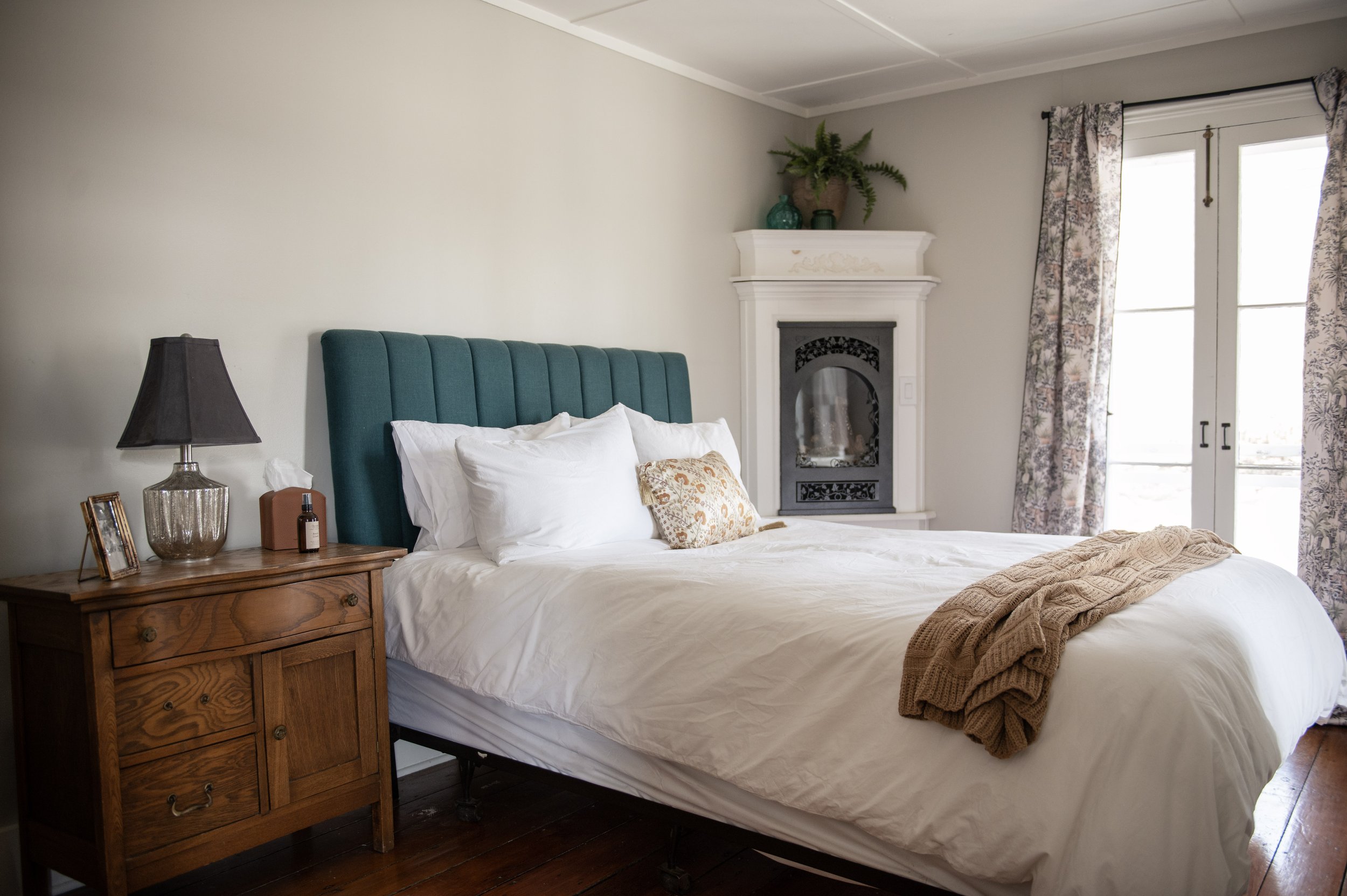 Room 1 - Queen Bed - Ground Floor - Custom Corner Fireplace - Private Doors Open to Shared Wrap Around Terrace - Full Private Bath