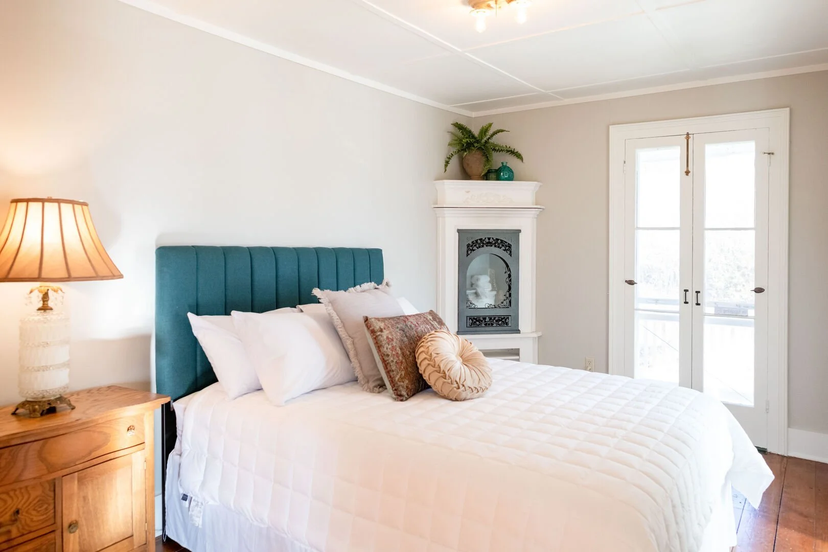 Room 1 - Queen Bed - Ground Floor - Custom Corner Fireplace - Private Doors Open to Shared Wrap Around Terrace