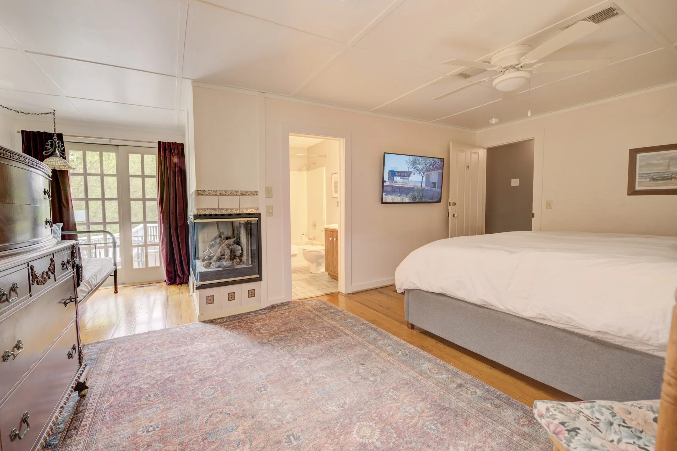 Room 4 at Park House Inn: king bed with a tufted bench and bright windows