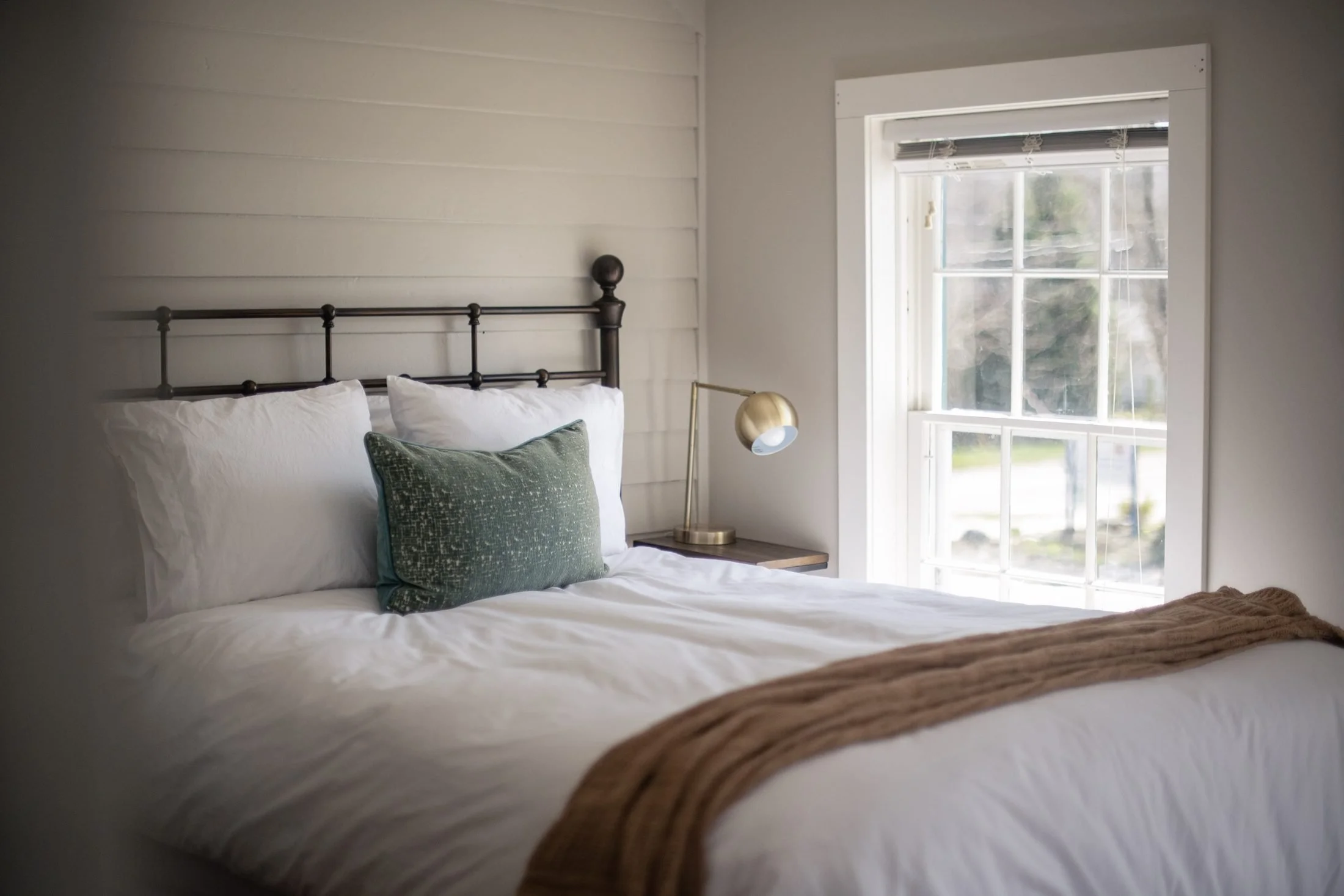 Room 3 at Park House Inn: iron bed with fresh white linens beside a sunny window