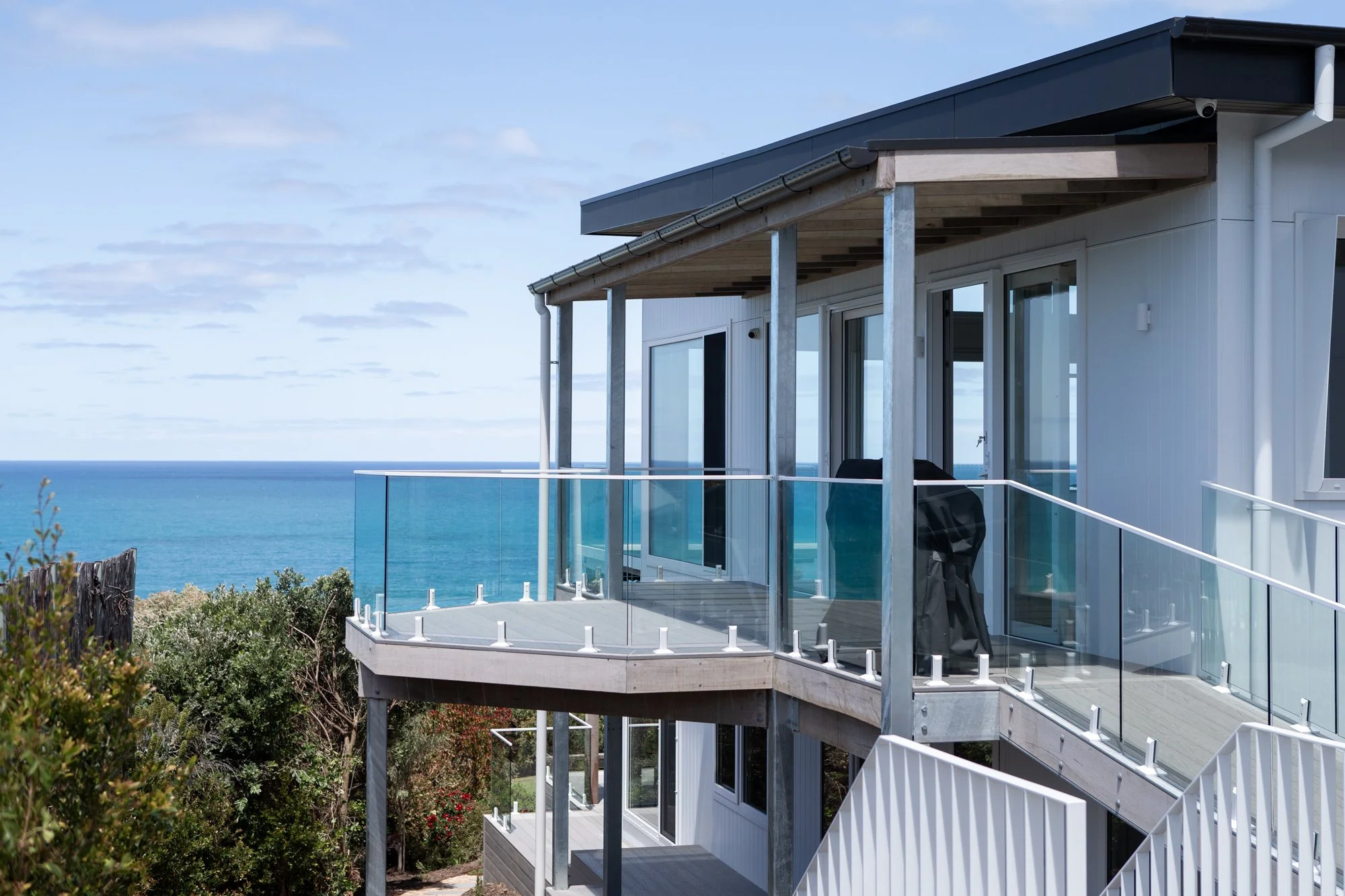 Window cleaning Surf Coast — coastal home with glass balustrade balcony overlooking the ocean
