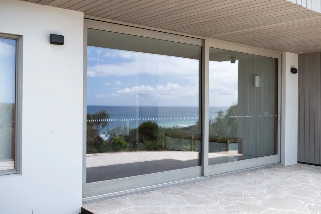 New build window cleaning Surf Coast — large frameless glass panels in multi-storey commercial construction site