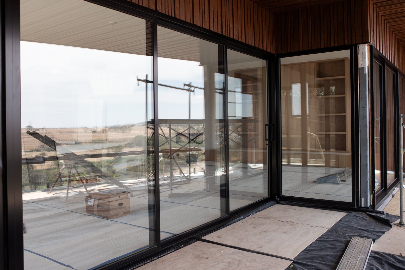 New build window cleaning Surf Coast — large frameless glass panels in multi-storey commercial construction site