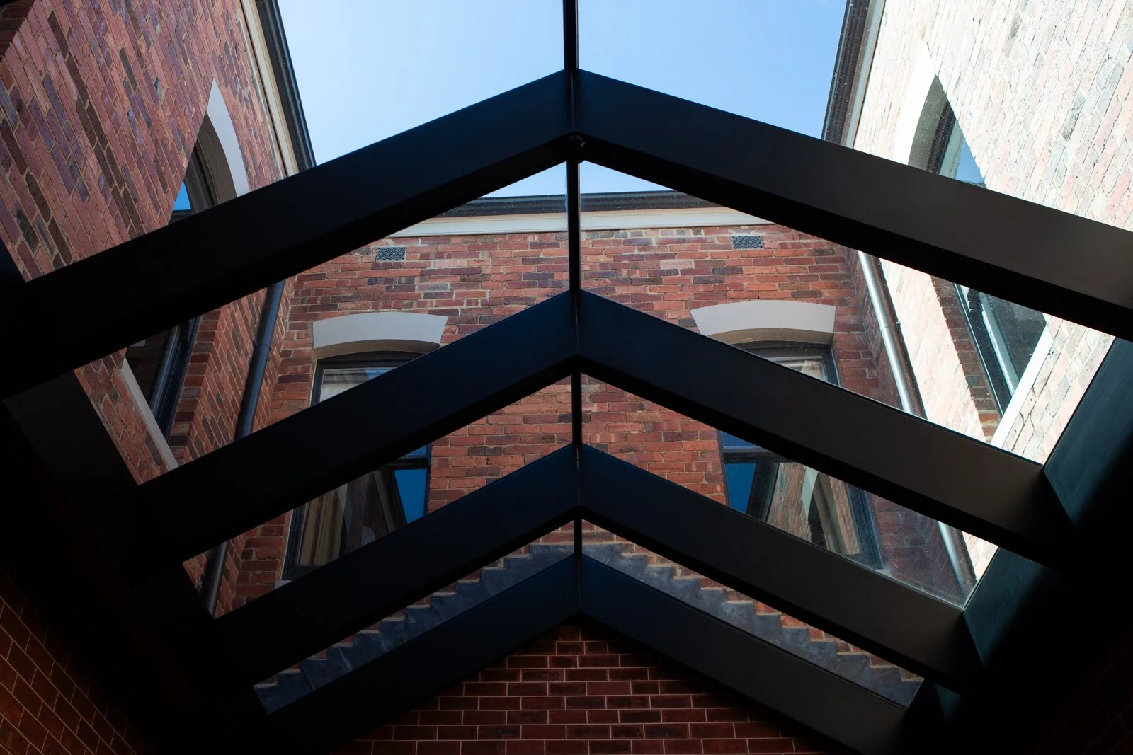 Commercial window cleaning Surf Coast — glass skylight roof panels in multi-storey brick building