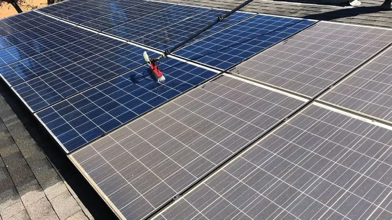 Solar panel cleaning Torquay — water-fed brush cleaning residential solar panels on rooftop