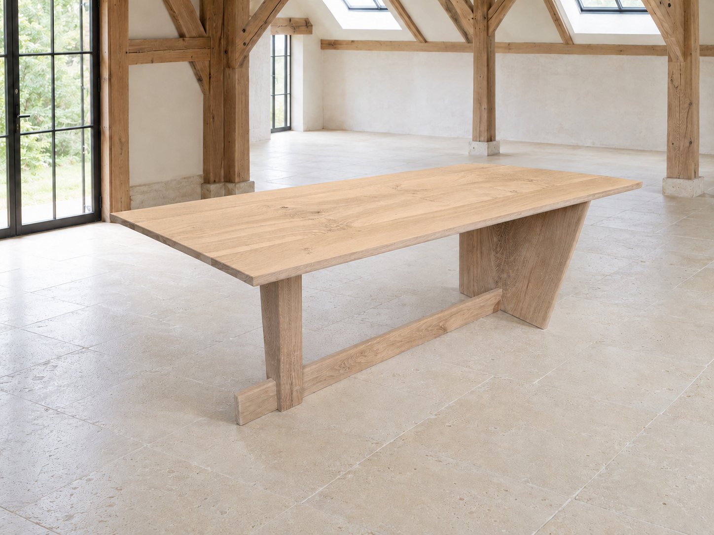 Oak Regata table in a spacious room with large windows and exposed wooden beams.