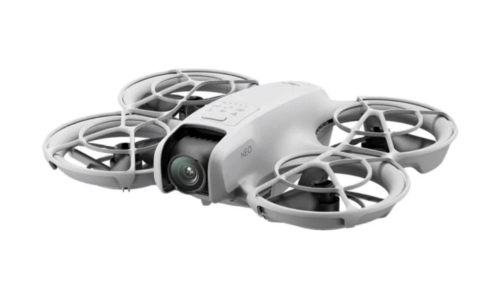 White drone with four propellers and camera mounted underneath.