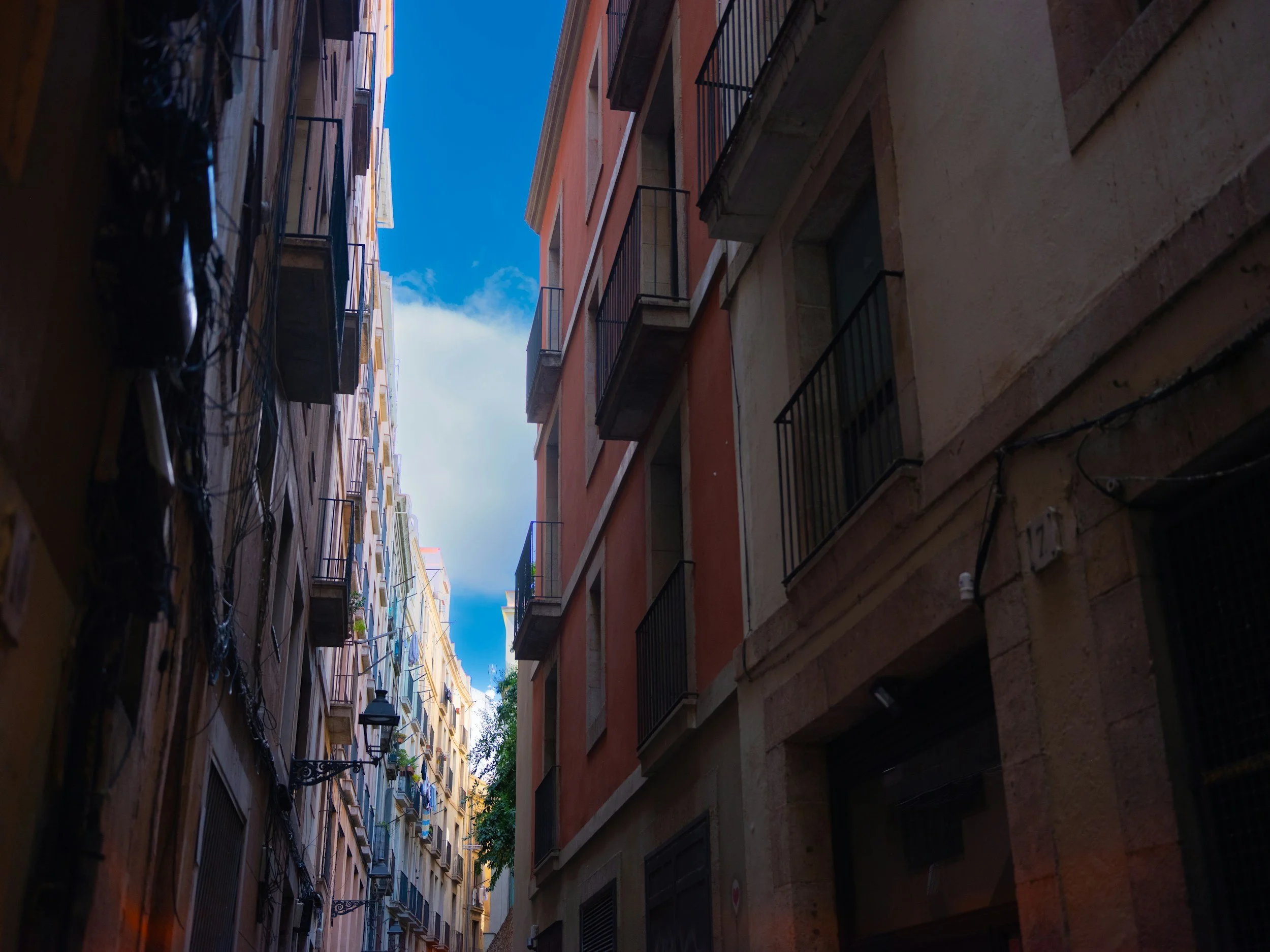 Spanish Culture Shocks, A narrow Spanish street with bright colours and a blue sky.