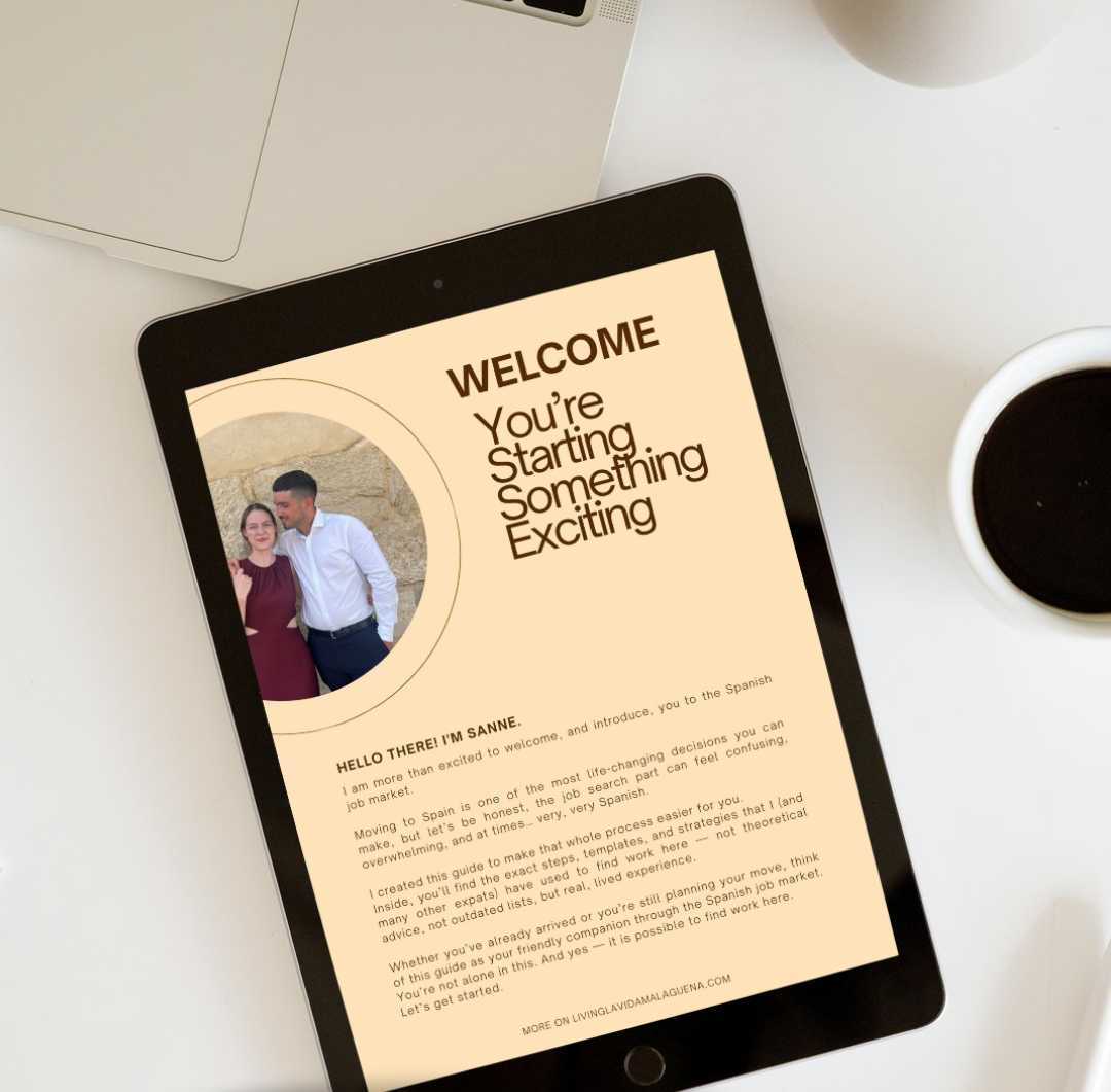 A tablet on a desk displays a welcome guide for learning Spanish, featuring a photo of a man and woman, with a cup of coffee nearby.