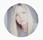 Blonde woman with long hair and light-colored eyes taking a selfie
