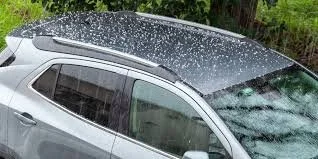 Paintless dent repair technician removing dent Hail Damage in Houston TX