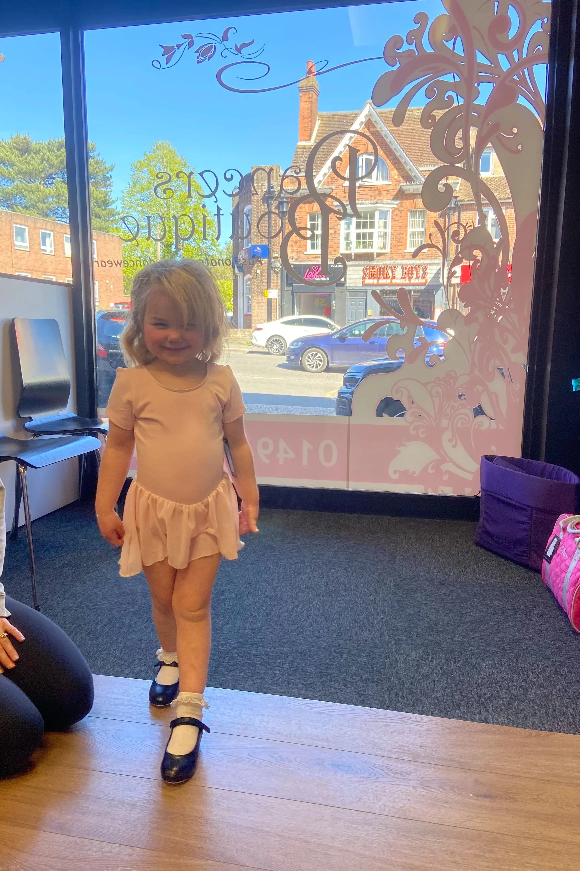 dancer from Maggie Monk School of Dancing trying on her ballet uniform and first pair of tap shoes from Dancers Boutique
