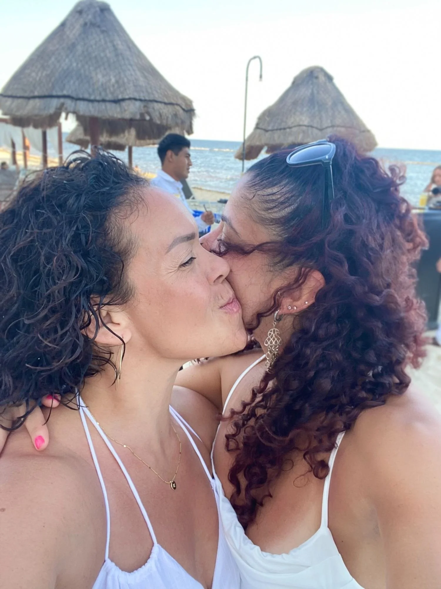 Barbara Vega embracing her chosen family soul sister Lorena at the beach, reflecting love, connection, and supportive sisterhood.