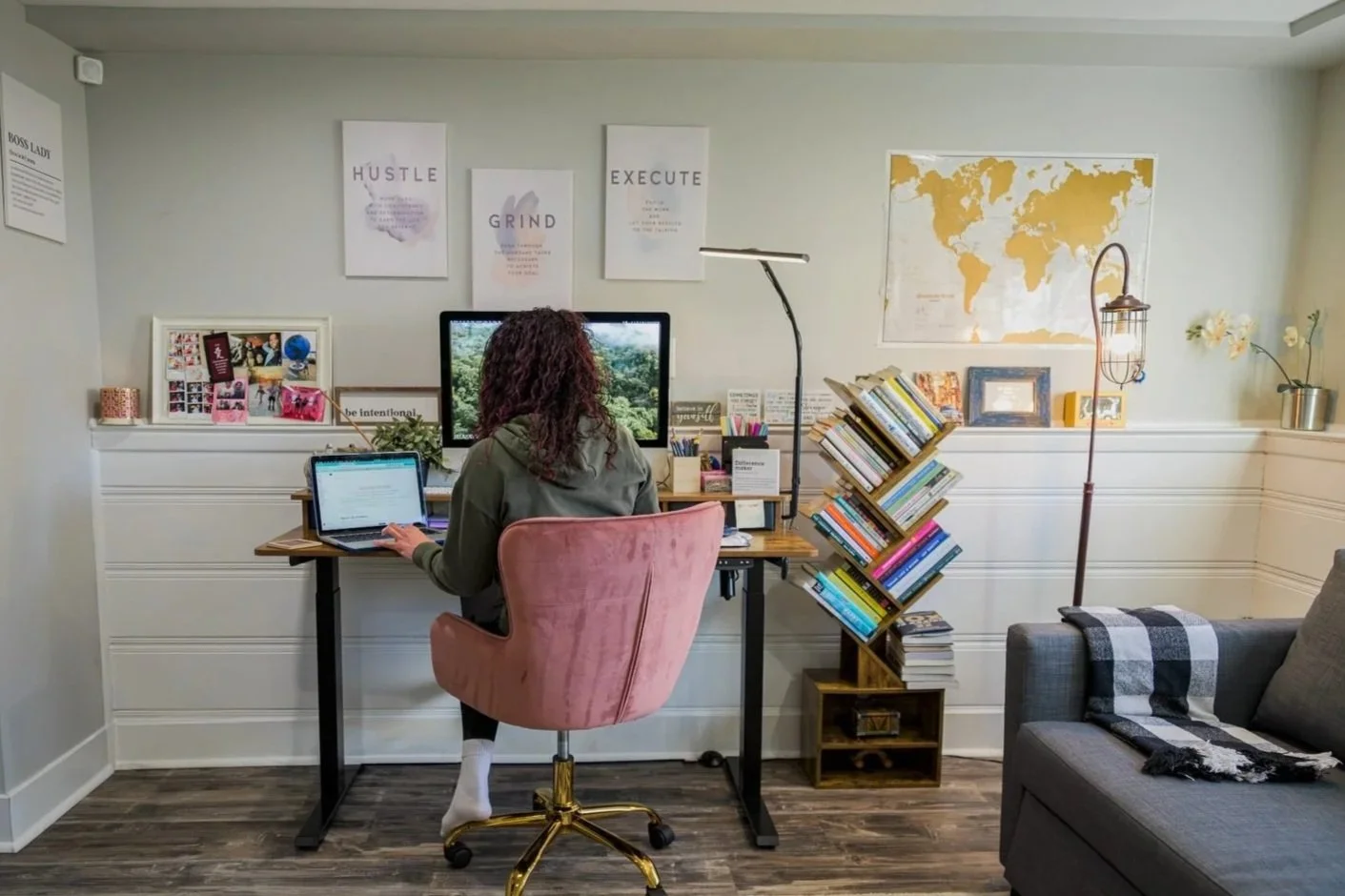 Latina nurse and wellness educator working on Fit-Her YOU blog in home workspace, focused on mind-body-spirit wellness for busy caretaking women