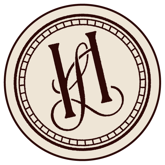A circular logo with a beige background and a brown border. Inside, stylized initials 'L' and 'T' are intertwined in dark brown.
