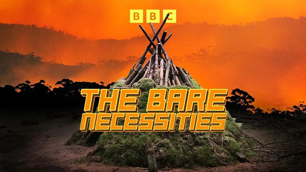 Illustration of a traditional shelter made of wooden sticks against an apocalyptic red background, with the BBC logo and the title 'The Bare Necessities' in bold text – a 2026 BBC Radio 4 series by writer Dan Richards.