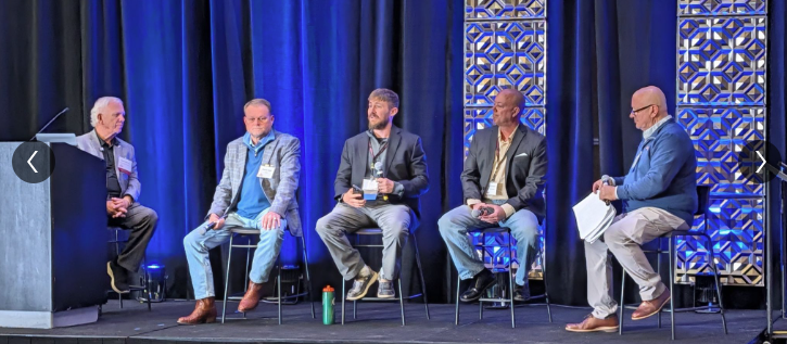 Panel discussion with industry leaders during construction safety event.
