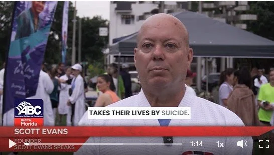 Scott Evans being interviewed at public event about construction suicide, mental health at the ABC of Central Florida Robe Walk.