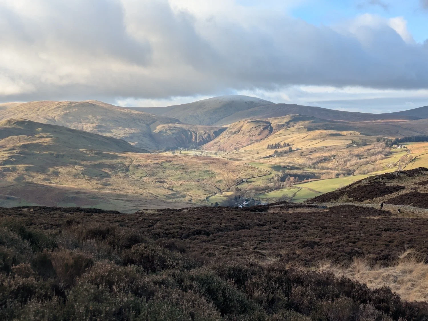 Matterdale valley landscape north of Ullswater, showing farmland, fells and open countryside.