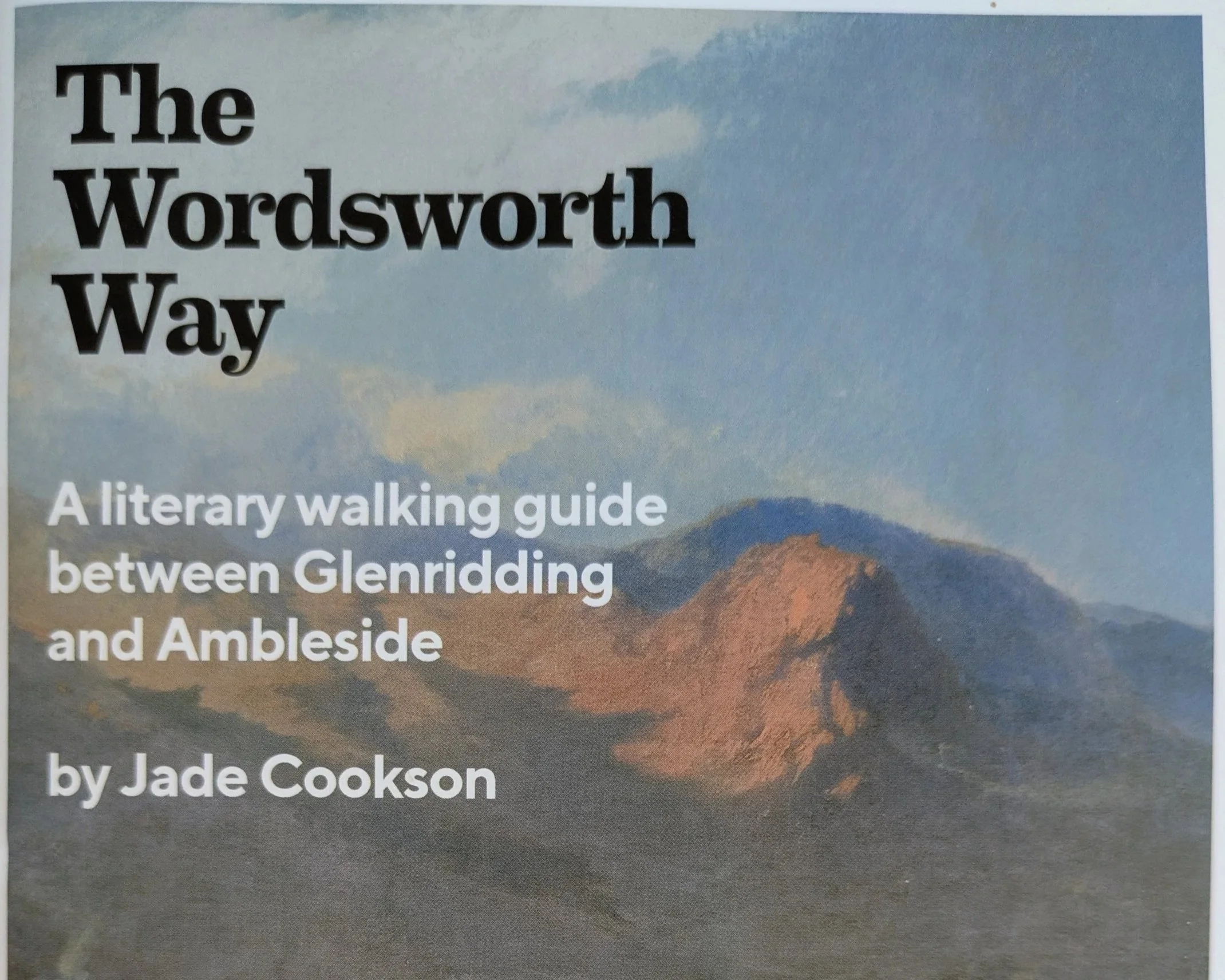 Walking guide titled 'The Wordsworth Way', a literary walking guide between Glenridding and Ambleside, by Jade Cookson, with a background image of a mountain landscape under a cloudy sky.