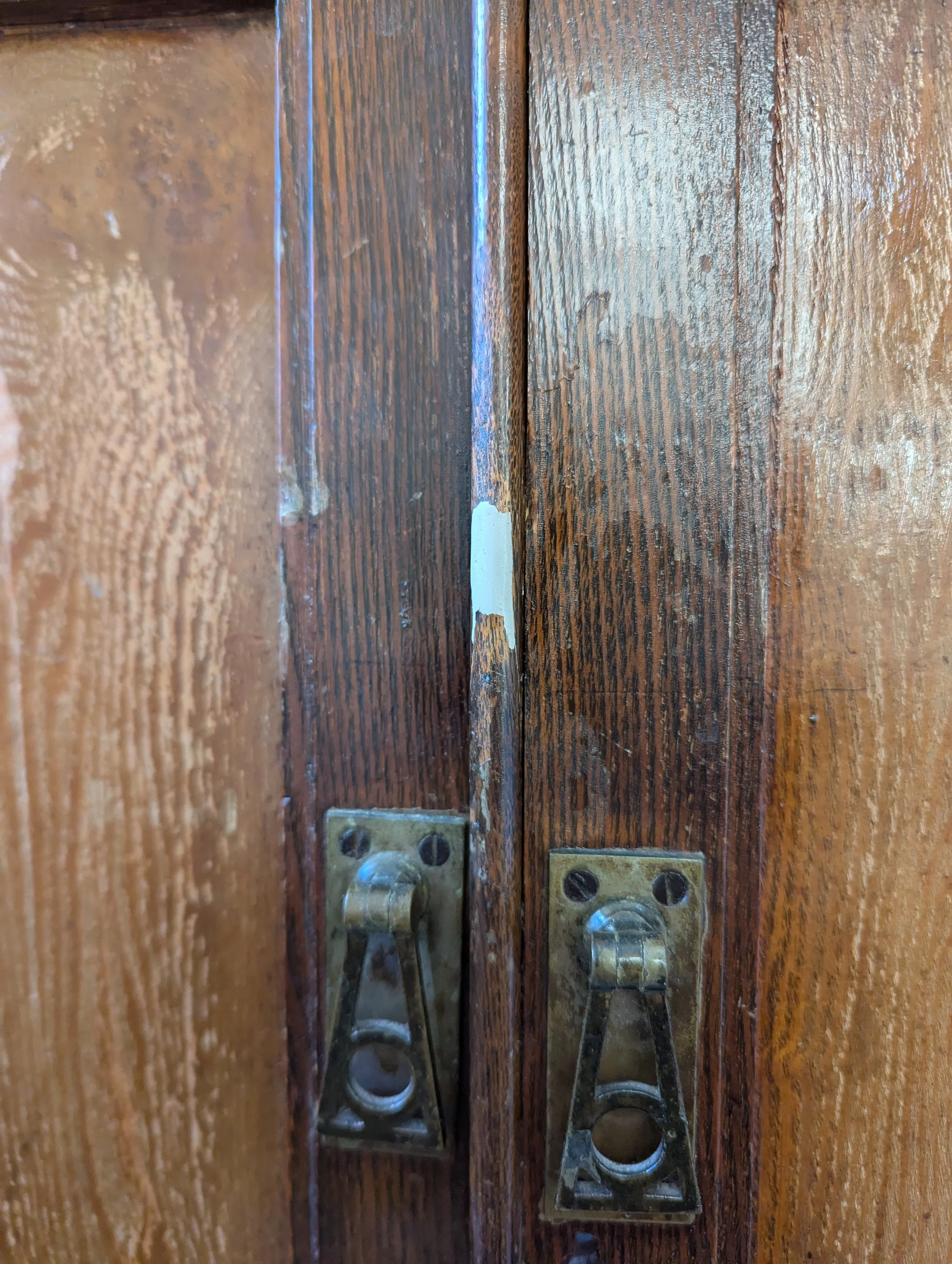 The image shows a damaged antique cabinet furniture, with a chip and scratch damage before the furniture repair occurs