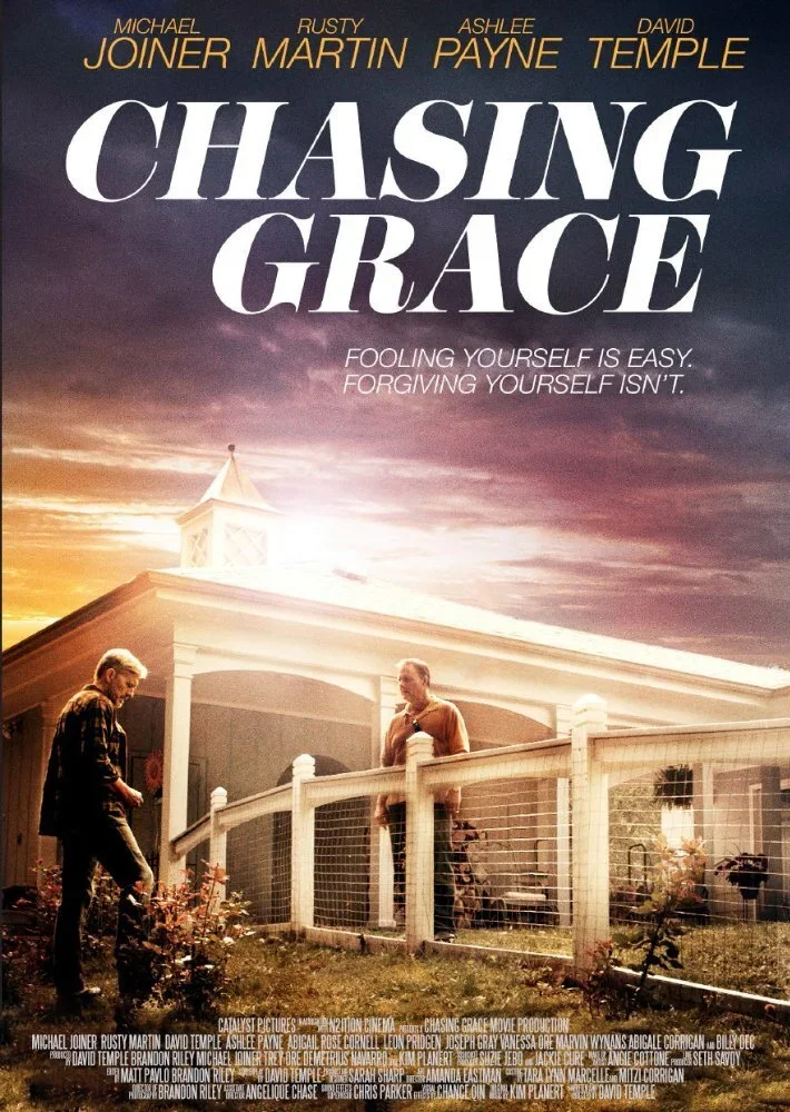 The movie poster for "Chasing Grace" features two men in a yard with a house in the background at sunset. The title is in large white letters across the top, with cast names above it. The tagline reads, "Fooling yourself is easy. Forgiving yourself isn't."