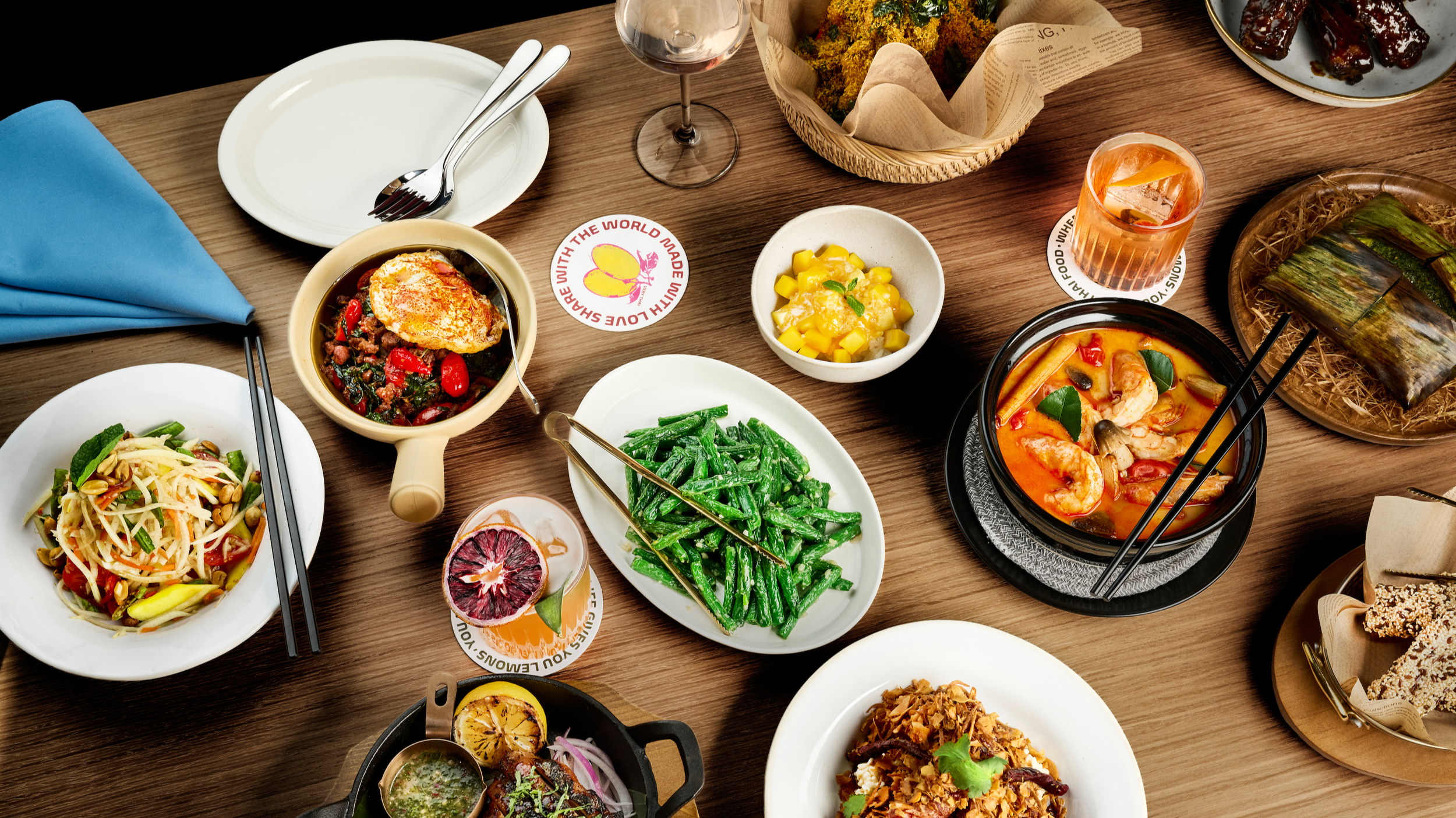 A modern Thai dining table filled with colorful dishes, fresh vegetables, and shared plates, highlighting a social and contemporary Thai food experience in LA Very Thai Westfield Century City.