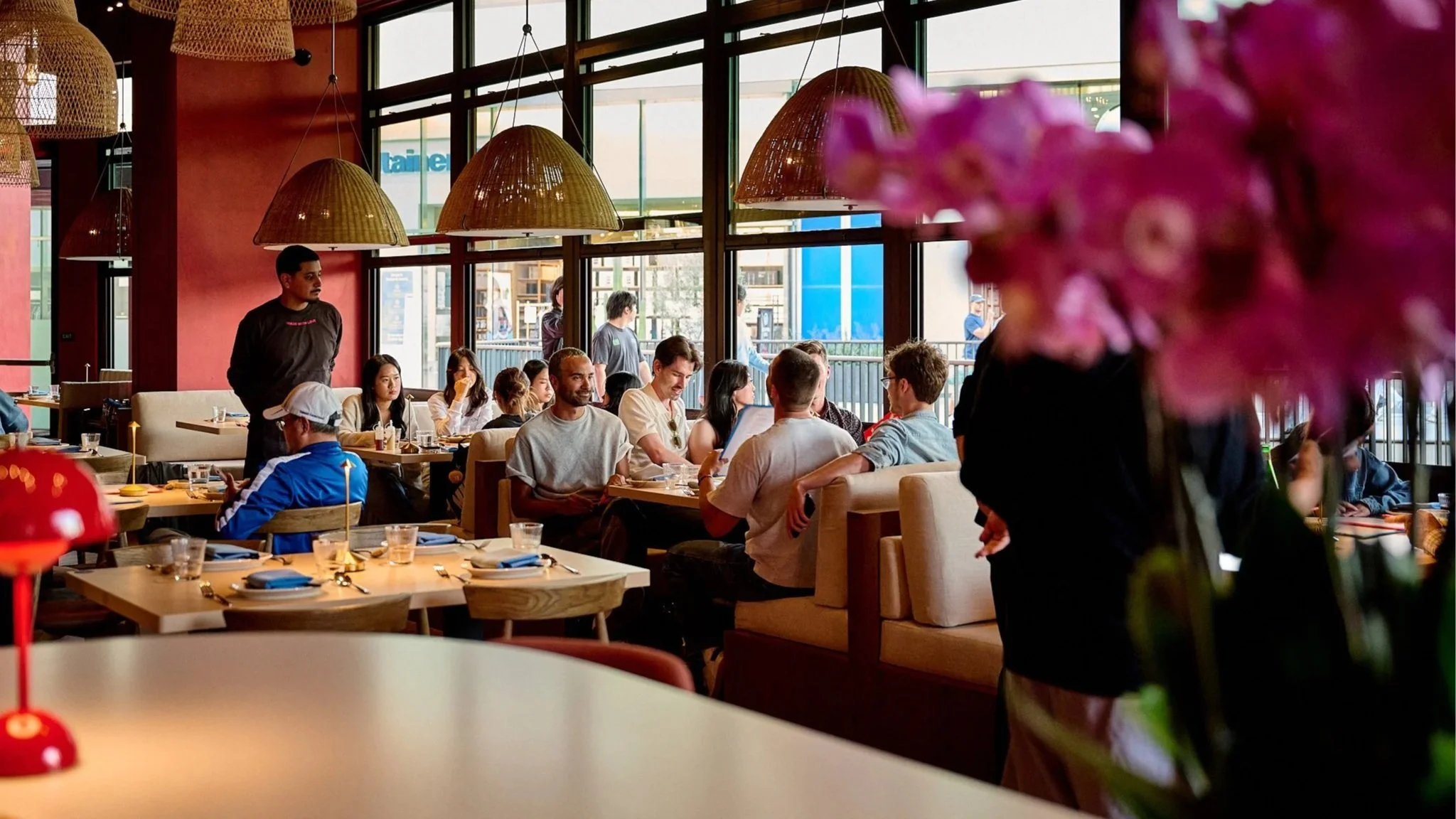 Guests enjoying a lively dining experience in a modern Thai restaurant, emphasizing social and communal dining in LA Very Thai Westfield Century City.