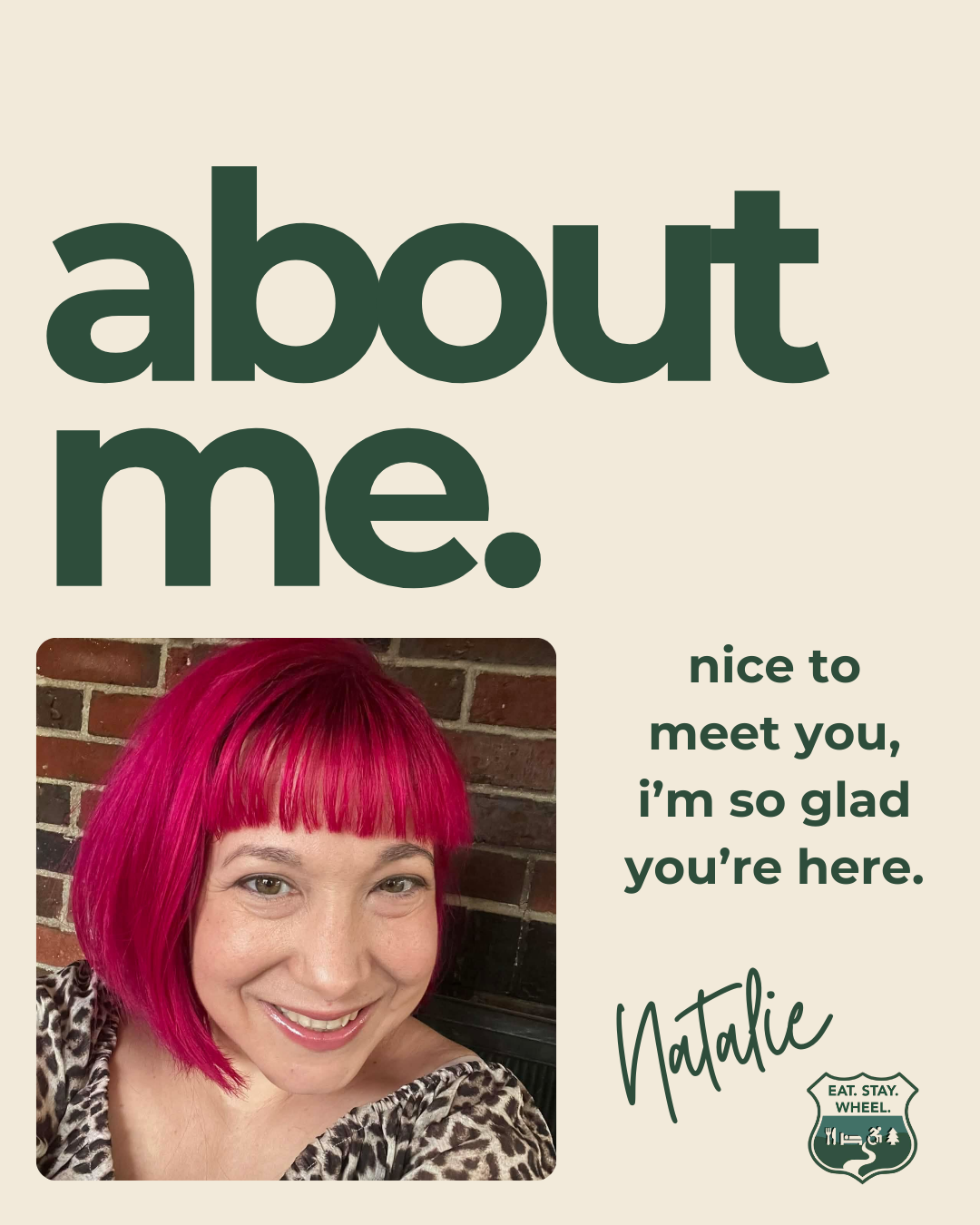 Natalie, founder of Eat. Stay. Wheel., smiling with bright pink hair in front of a brick wall.
