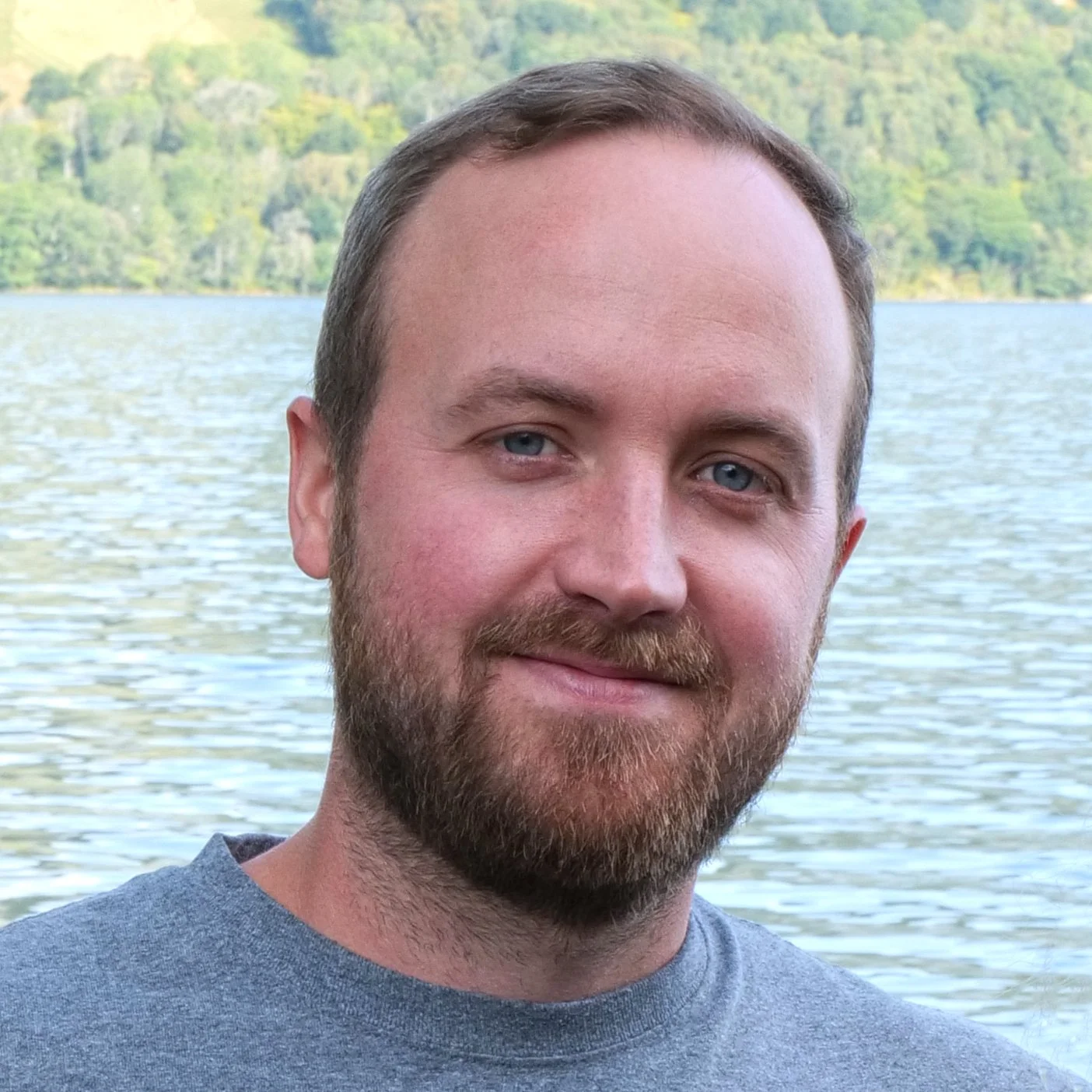 photo of Eli Anderson, Children's Book Author, in front of a body of water