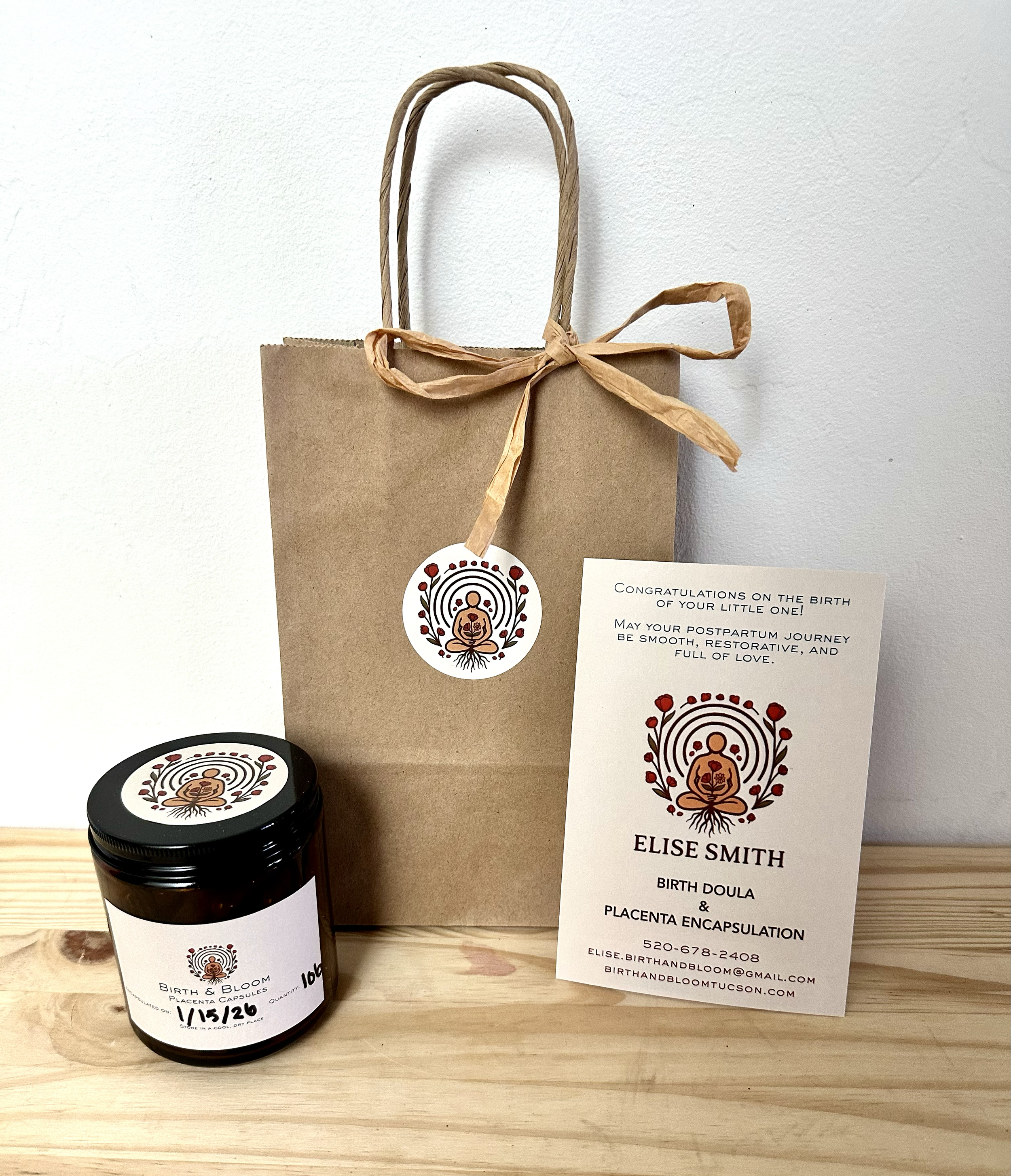  a brown glass jar of placenta capsules, placenta capsule instructions, and a Birth and Blood Placenta Encapsulation & Doula Services brown gift bag. 
Elise Smith Tucson AZ